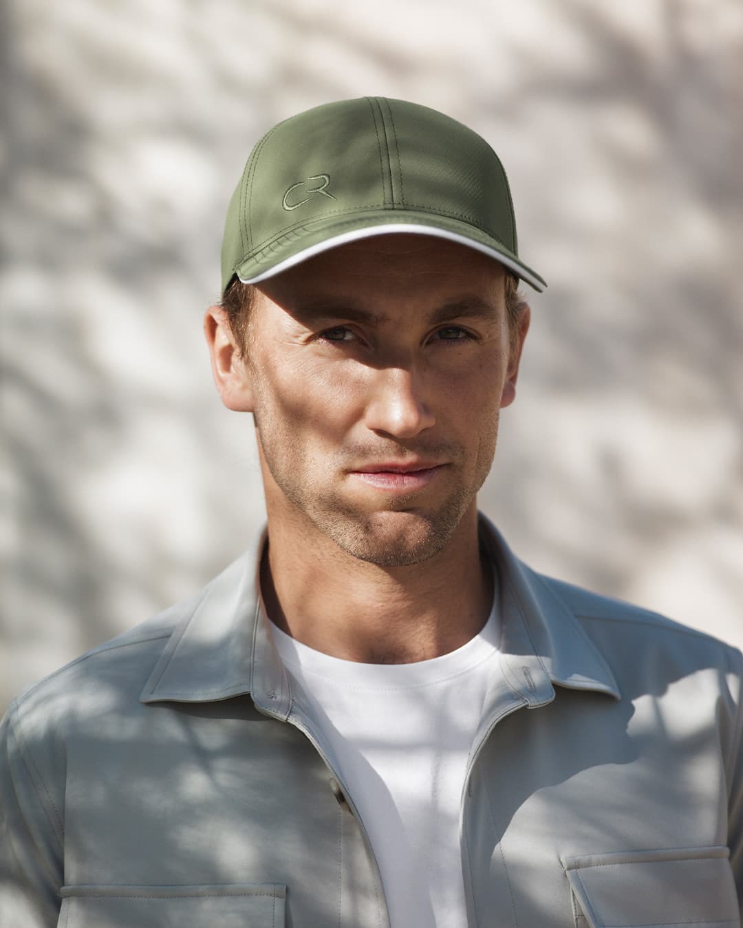 Front view of Casper Ruud wearing a green cap from Varsity Headwear