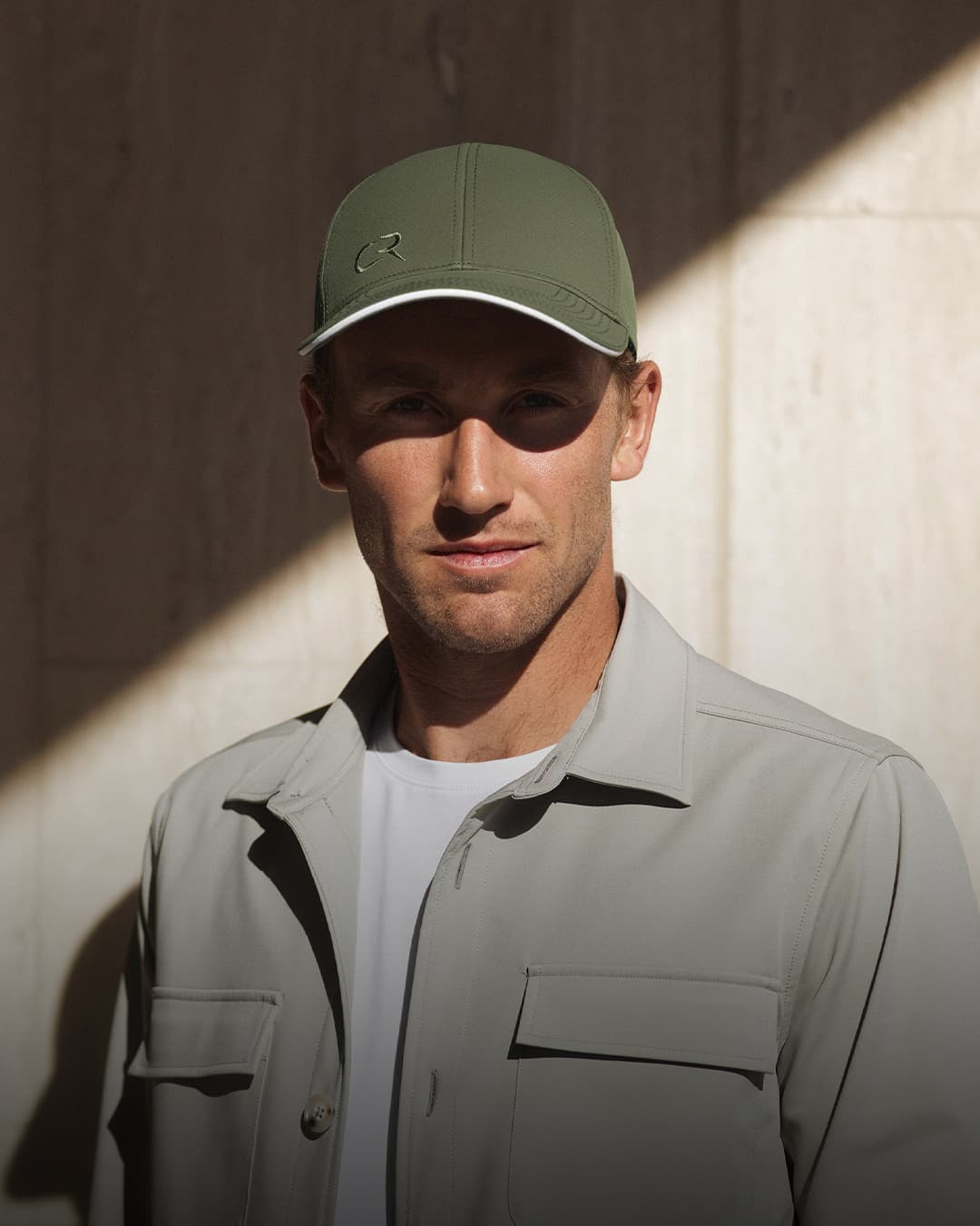 Front view of Casper Ruud wearing a green off-court cap designed in collaboration with Varsity Headwear