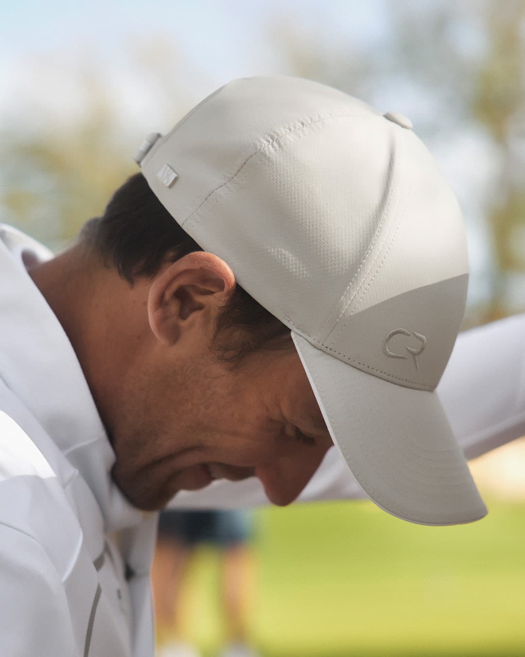 Side view of Casper Ruud on the Golf Course wearing the Off Court cap from varsity Headwear