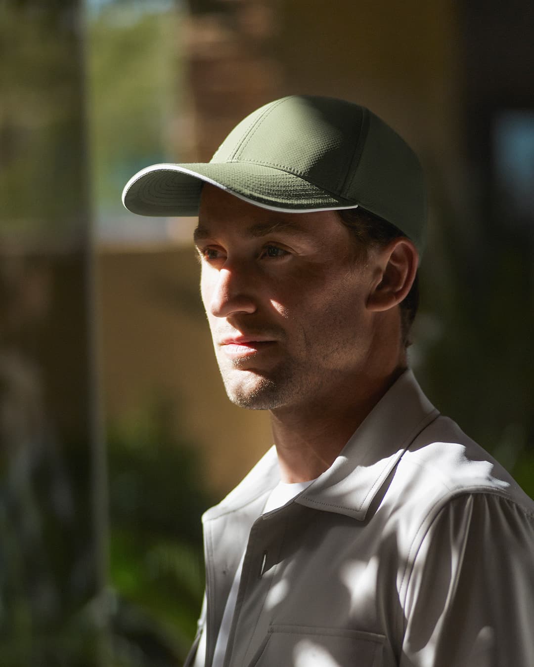 Side view of Casper Ruud wearing green cap designed in collaboration with Varsity Headwear