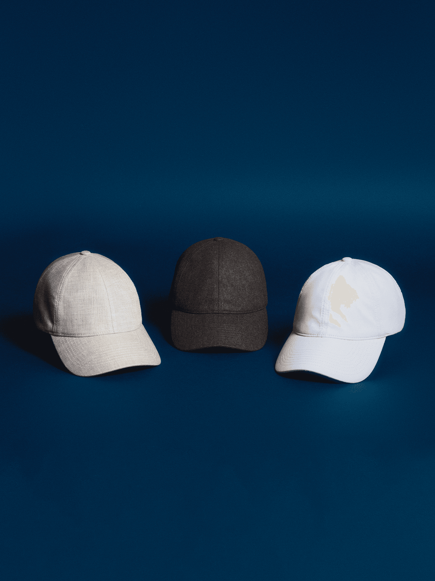 Front view of legacy soft starter pack from varsity headwear including a brown wool cap, a white sport cap and a beige linen cap