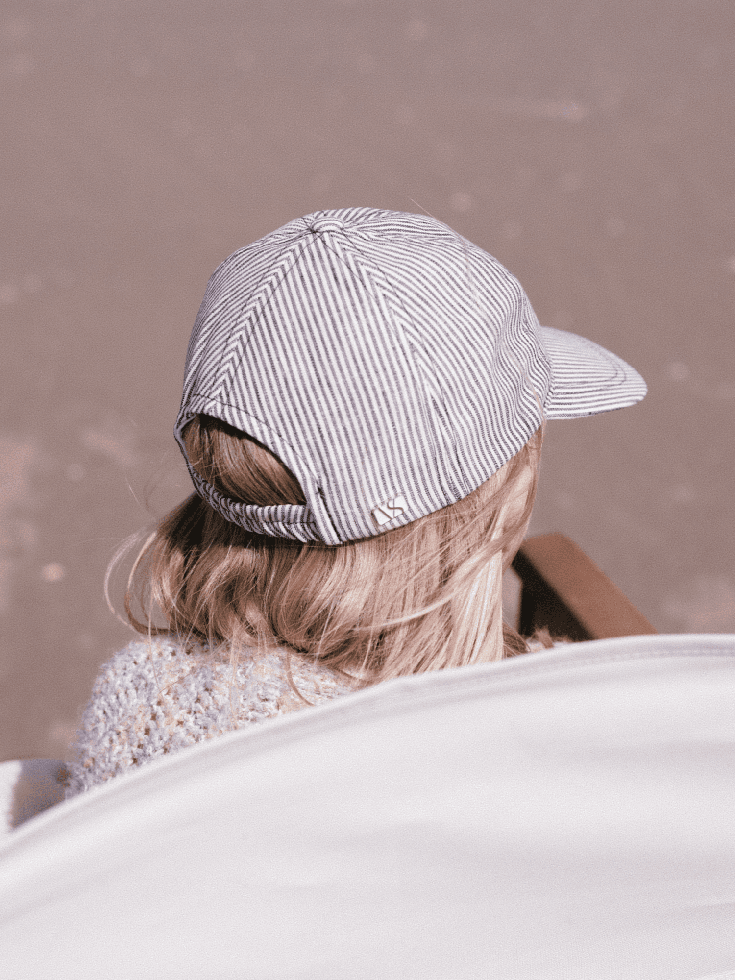 Back view of a striped kids linen cap from varsity headwear