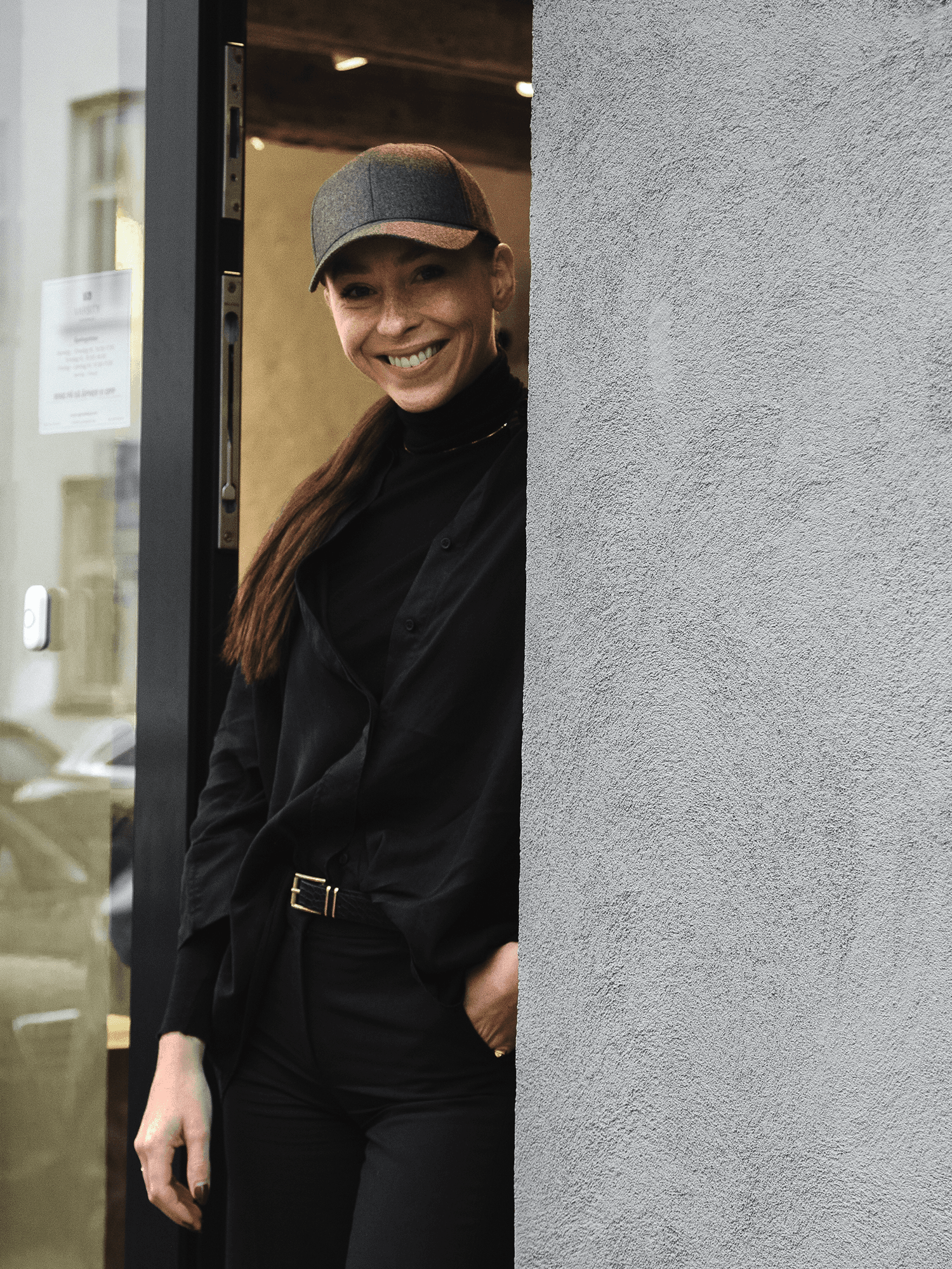 Store manager from Varsity headwear in varsity headwear store wearing a cap