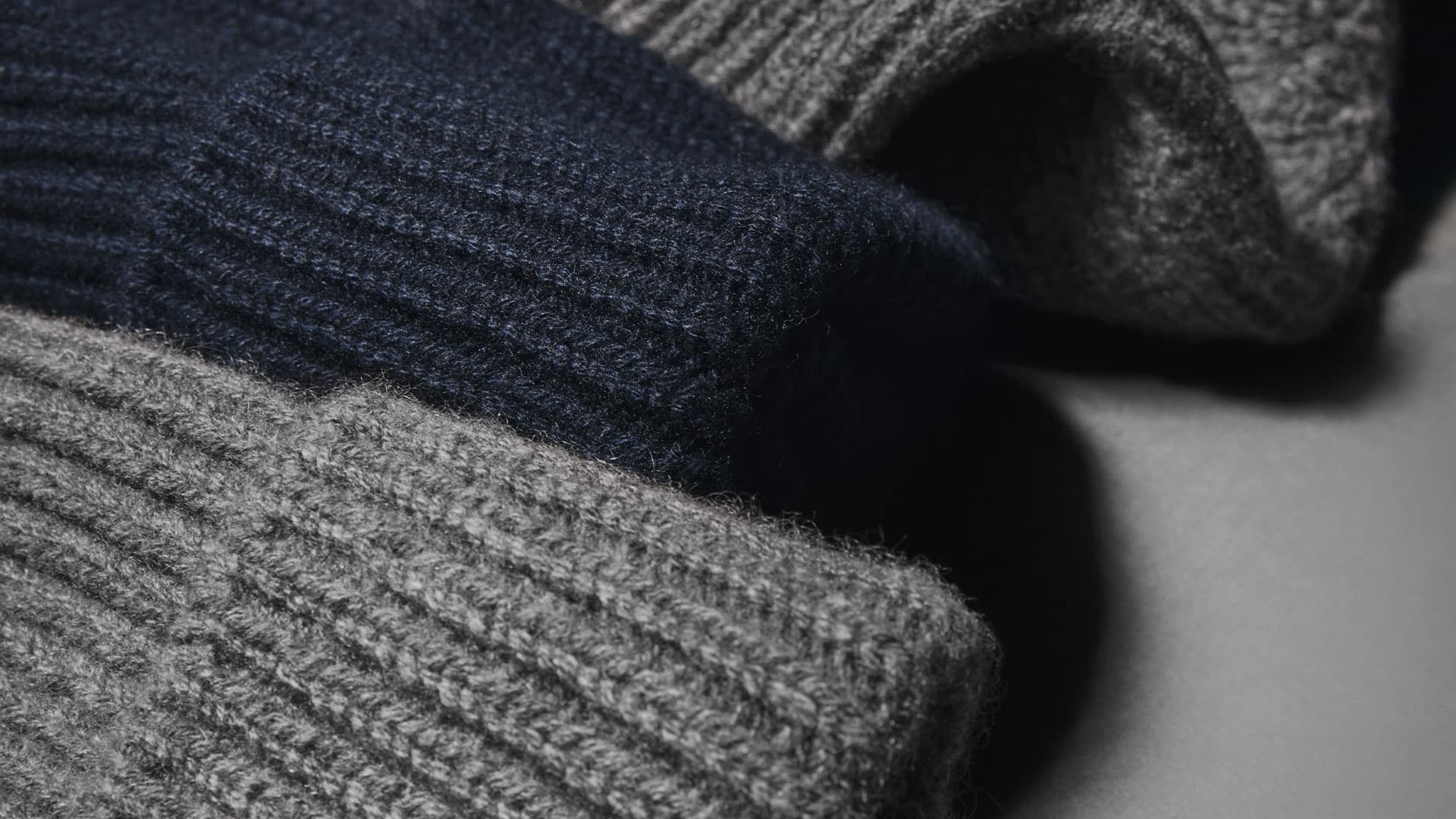 Close view of grey and navy cashmere wool blend beanies from Varsity Headwear