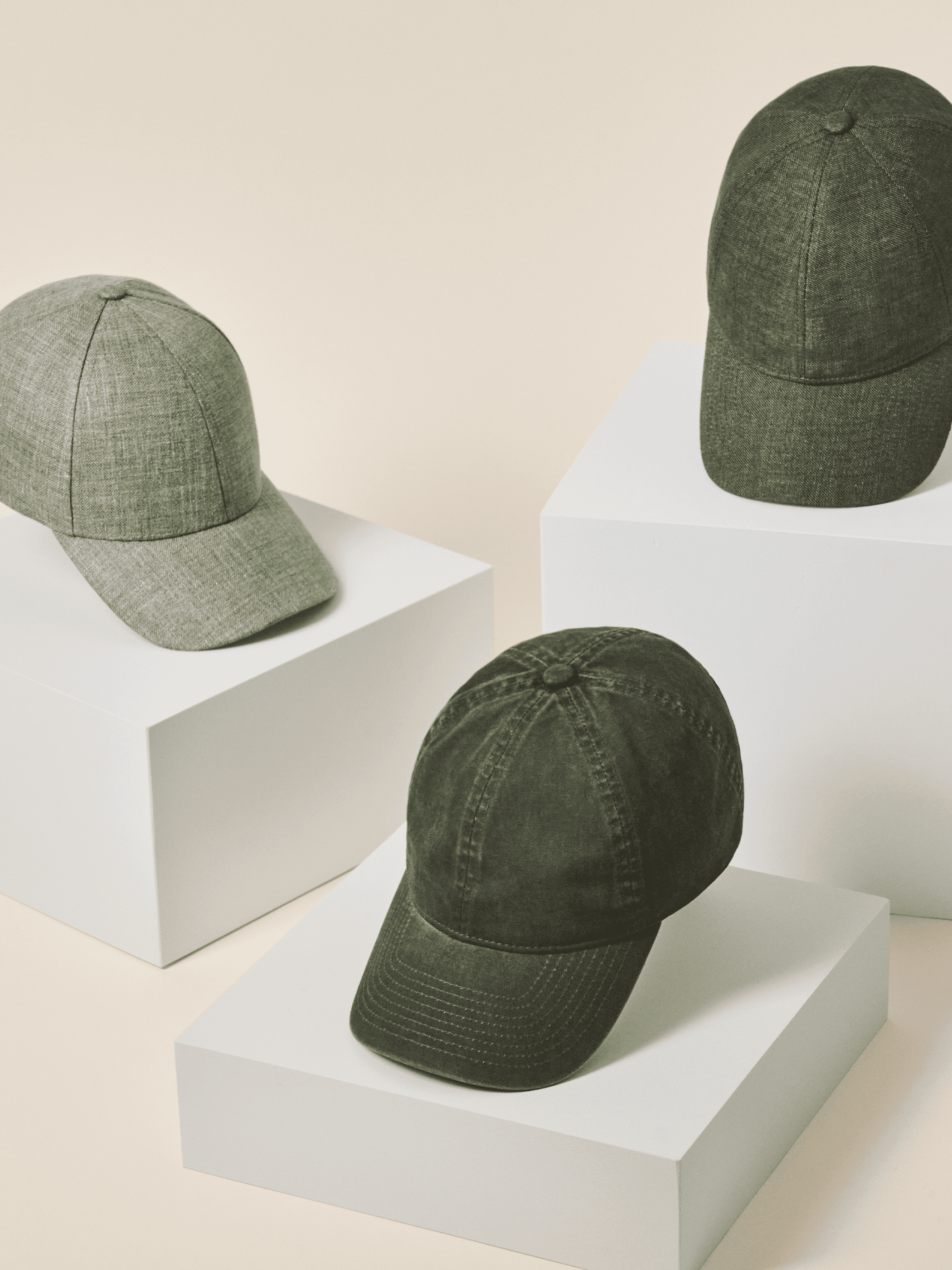 Front view of three green baseball caps in linen and cotton materials