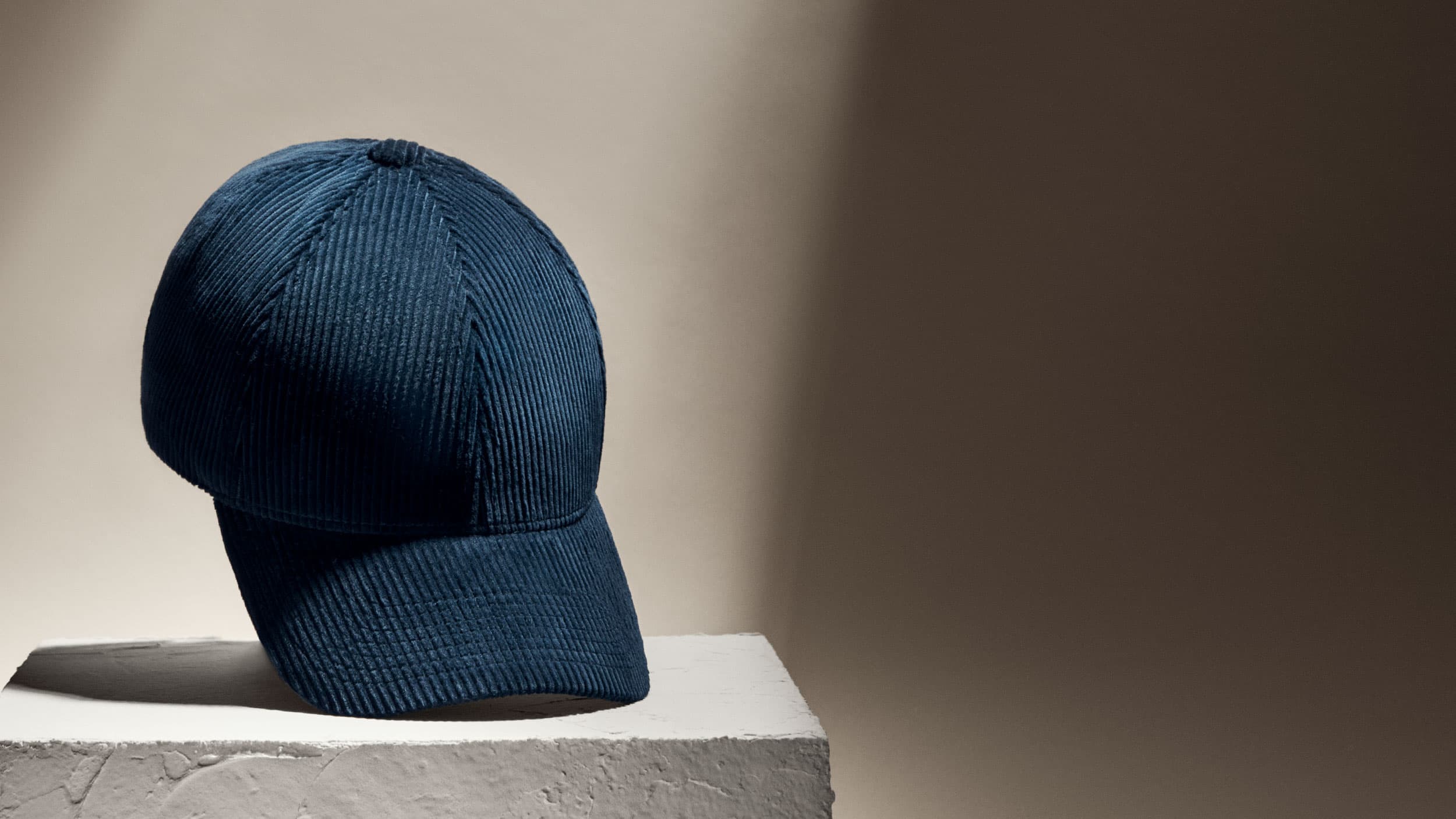 Front view of a navy corduroy cap from varsity headwear