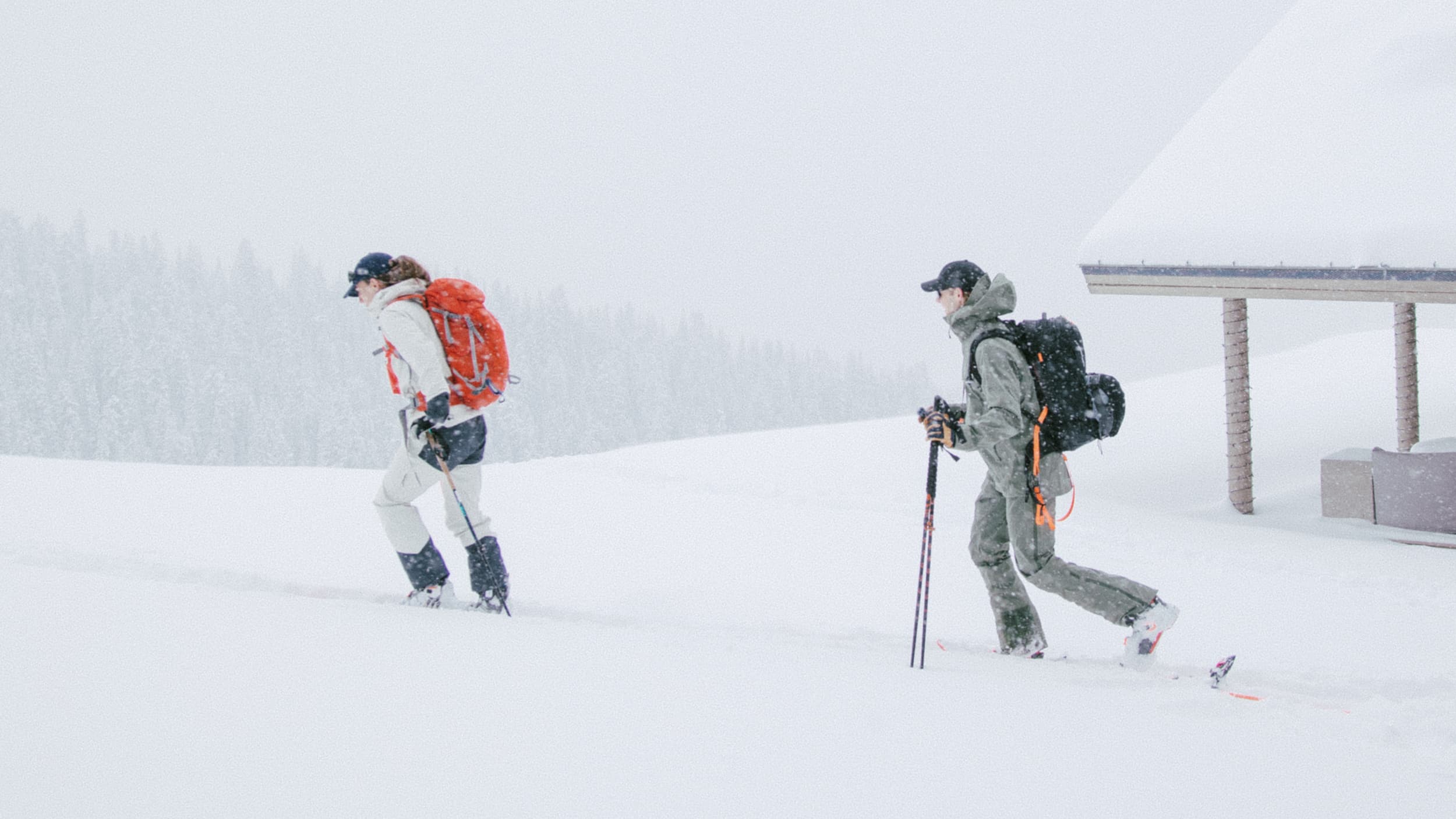 Two randonée skiers in a snowstorm in Aspen, Colorado wearing Varsity Headwear