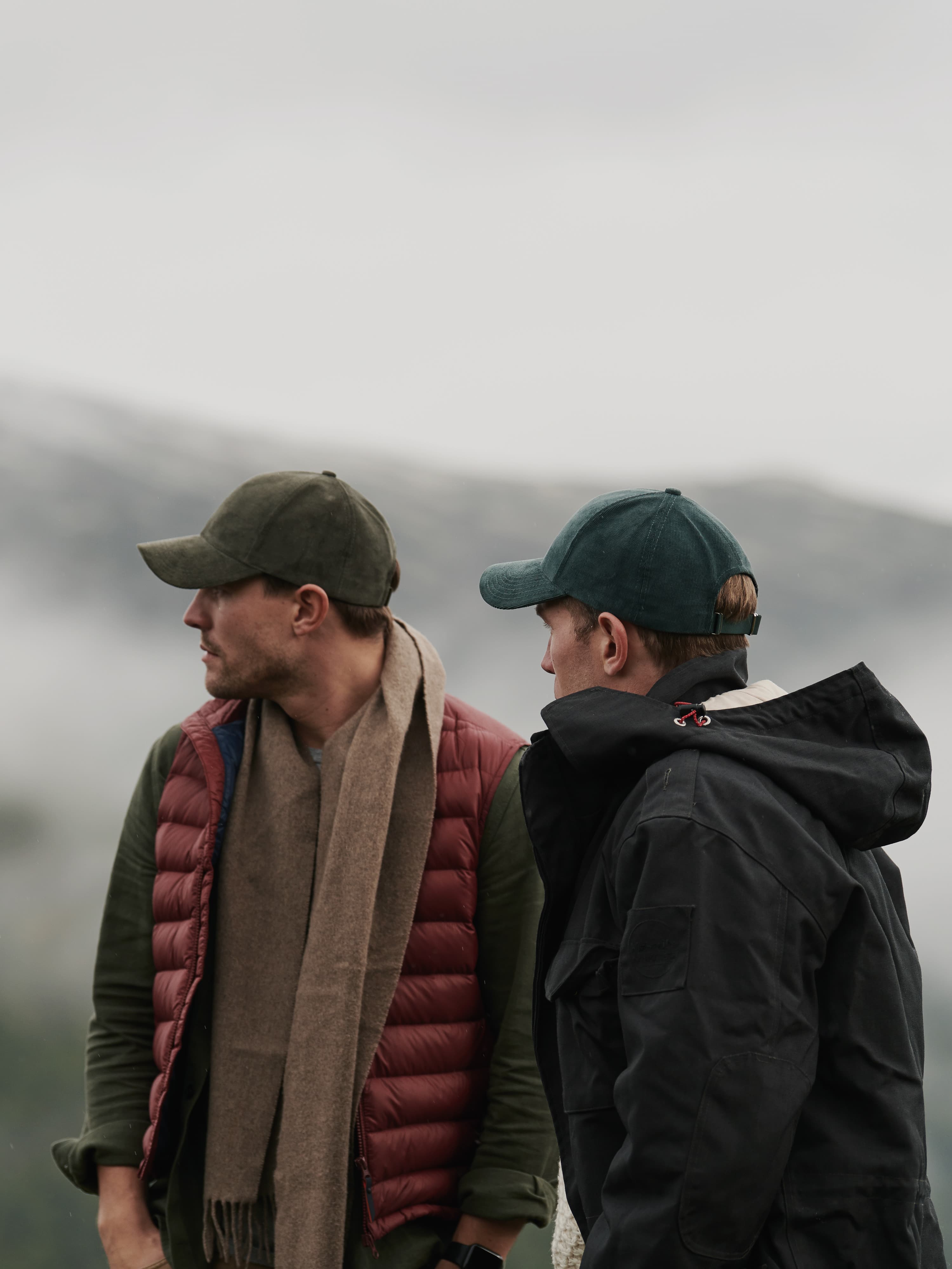 Side view of founders of Varsity headwear Sebastian and Alexander Adams in natural environment