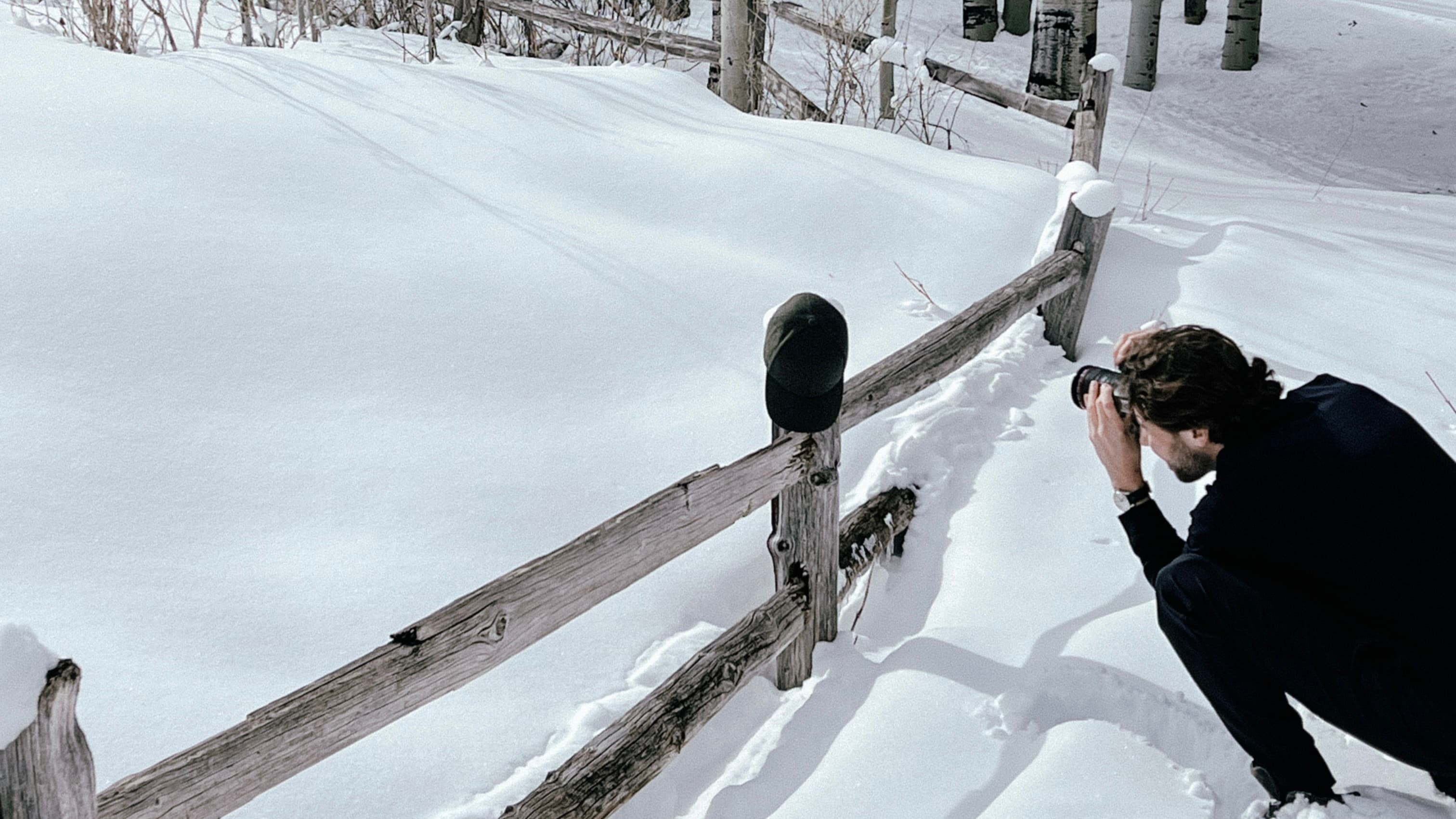 BTS image of photographer shooting cap in snowy environment