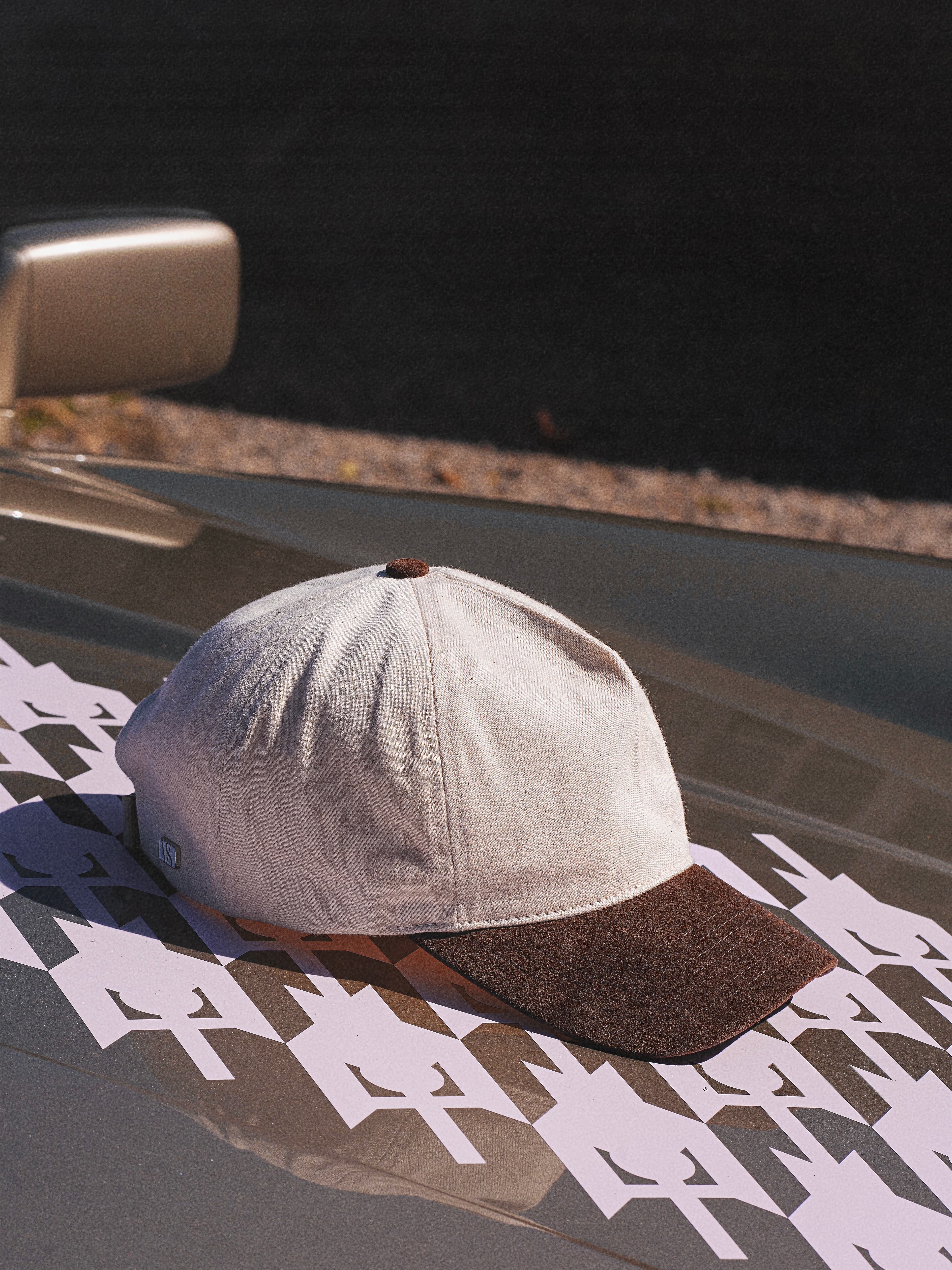 Side view of the white denim and brown alcantara cap in Soft Cruz Shape