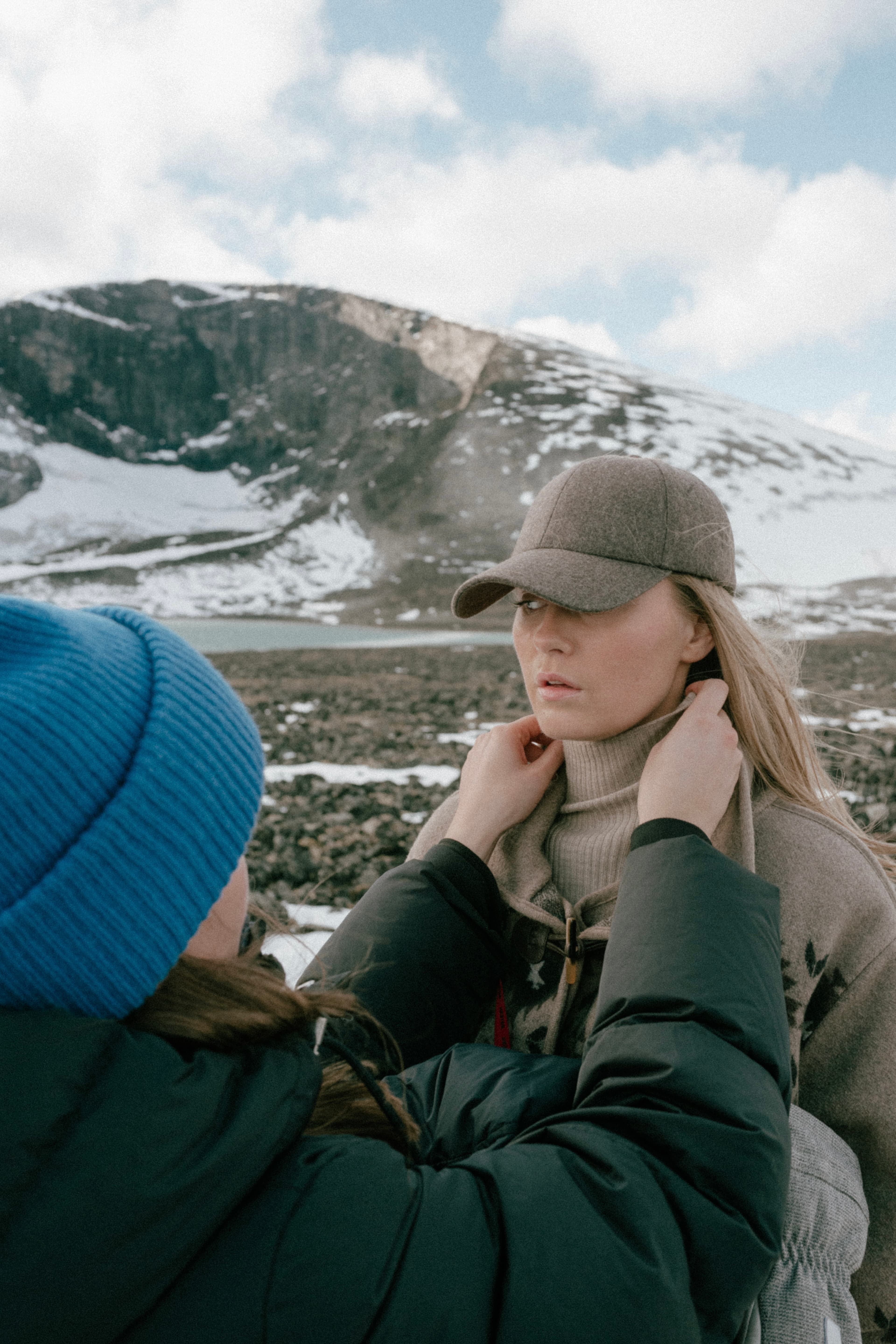 Behind the scenes photo of model wearing brown wool cap in campaign shoot for varsity headwear holiday campaign 2024