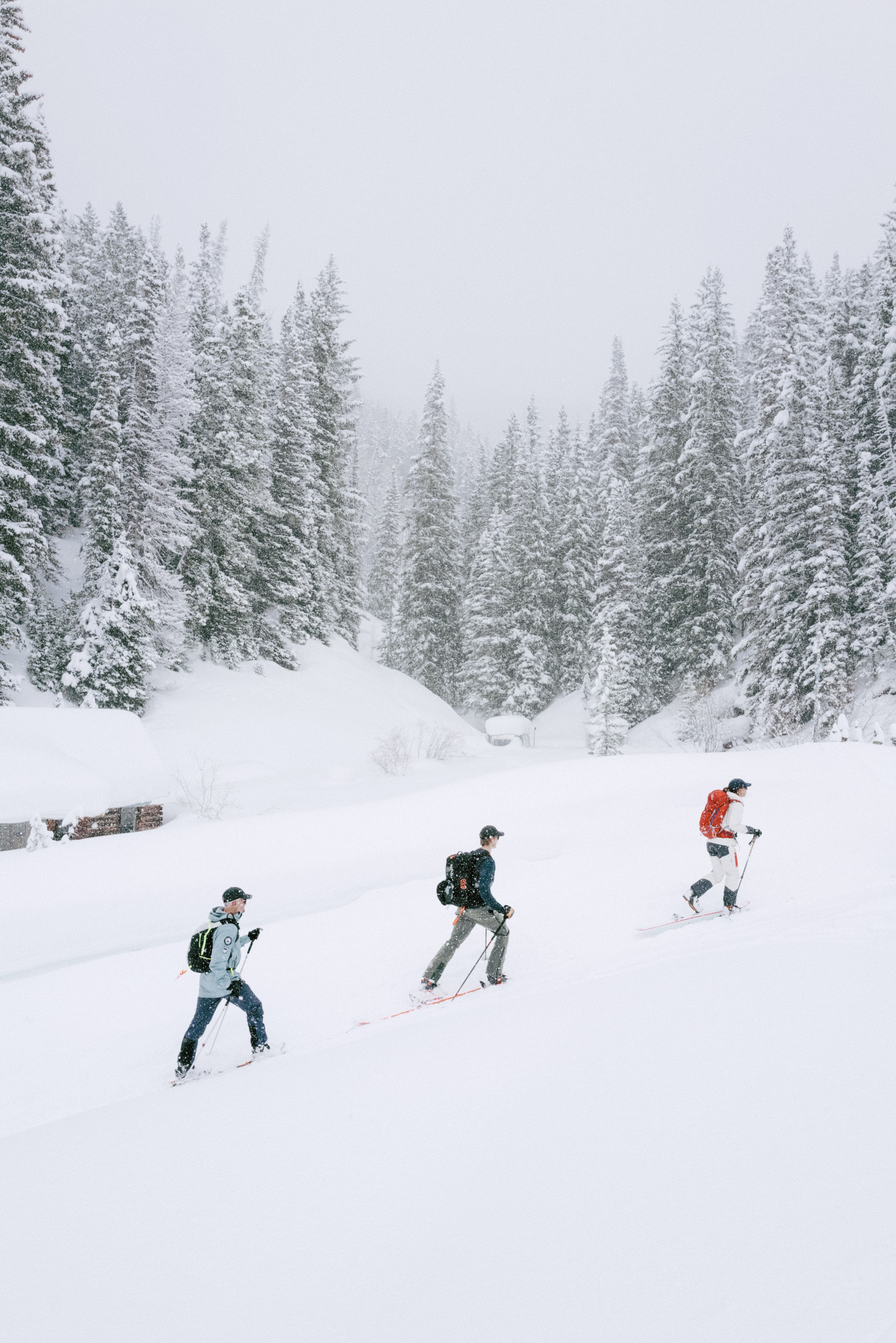 Side view of skiers wearing active tech cap in snowy environment