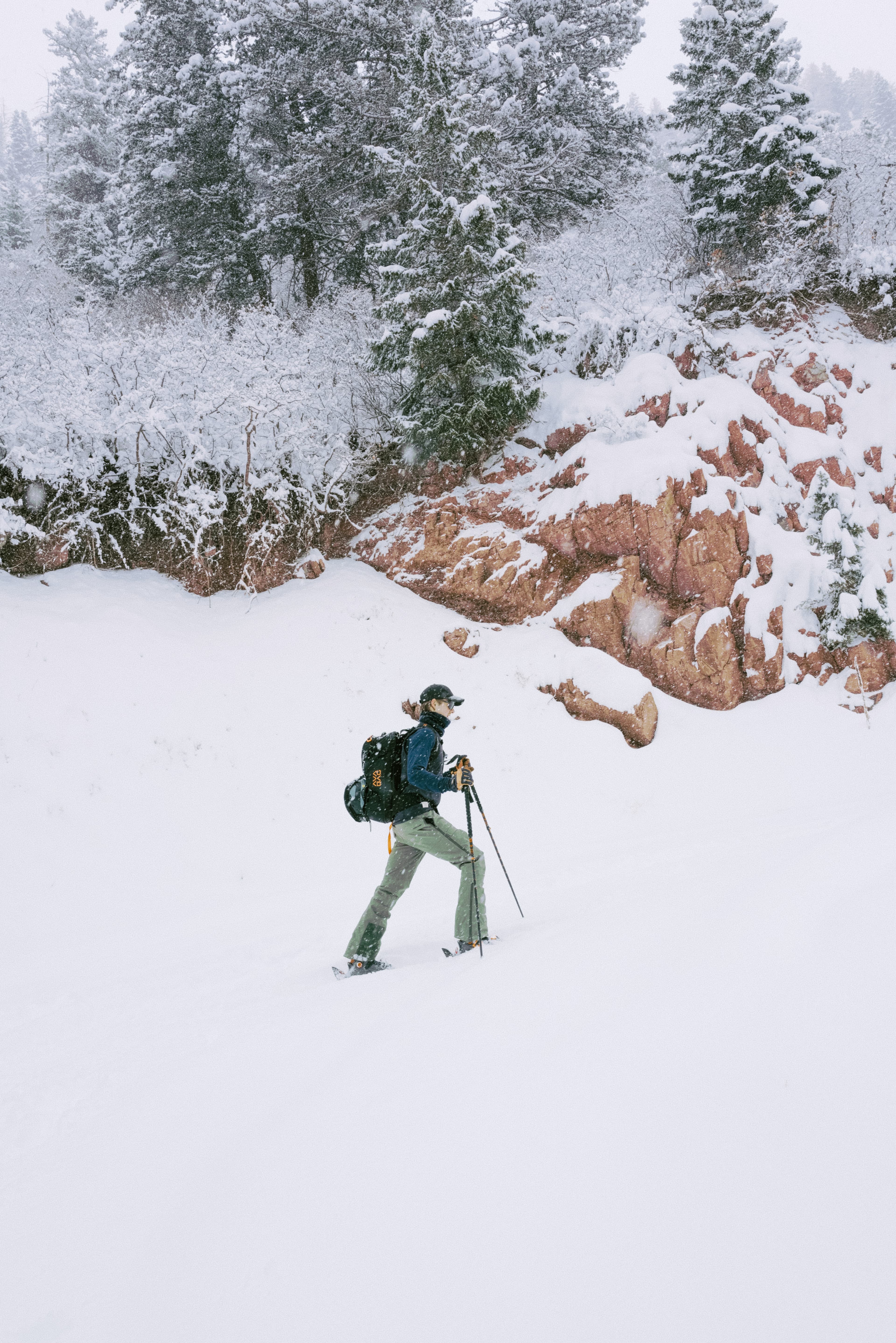 Side view of skier wearing active tech cap in snowy environment