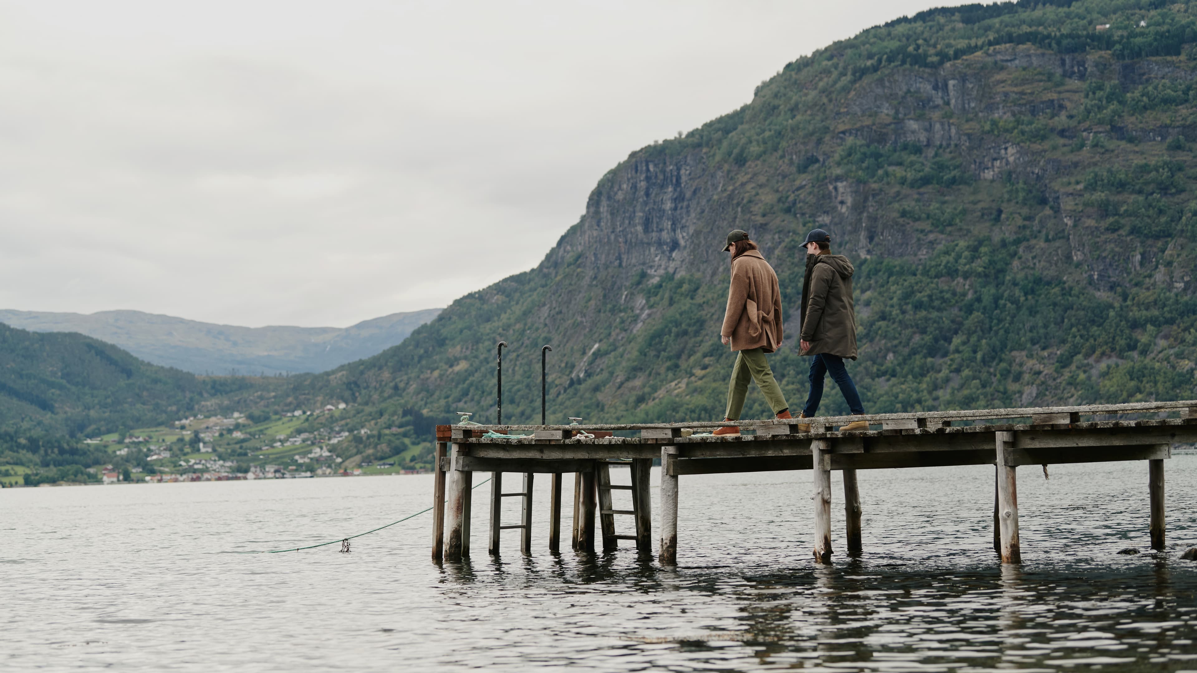 Landscape image of two people wearing varisty headwear caps