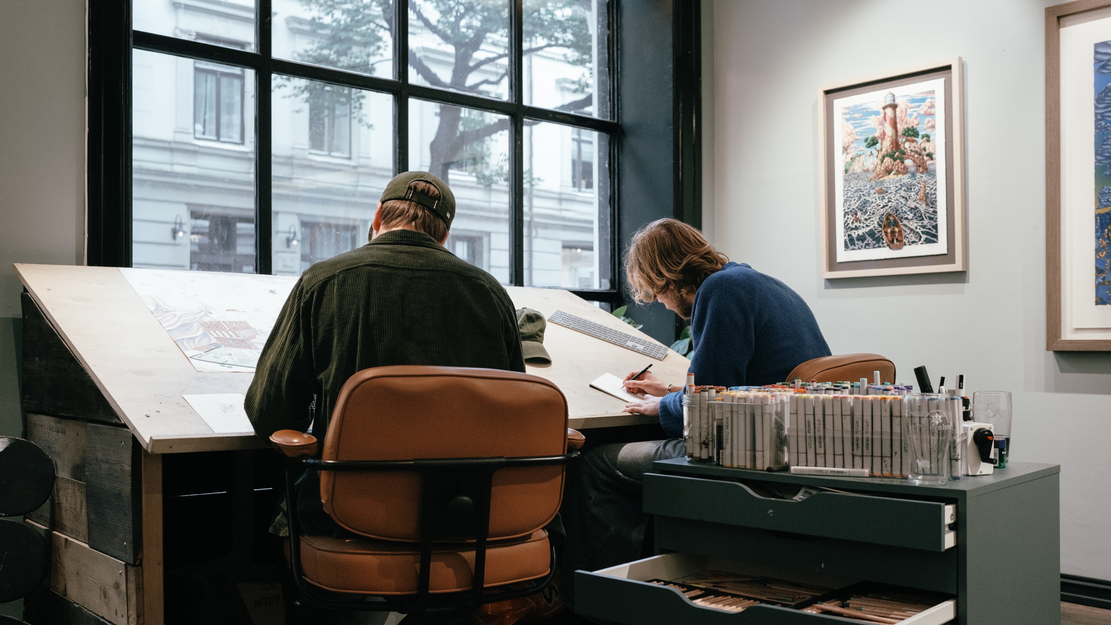 Guttestreker at work drawing the Varsity Headwear limited edition washed cotton baseball cap project in their Oslo, Norway workshop