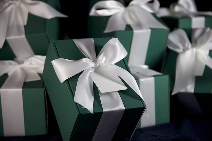 Front view of a green gift box from varsity headwear with a white ribbon