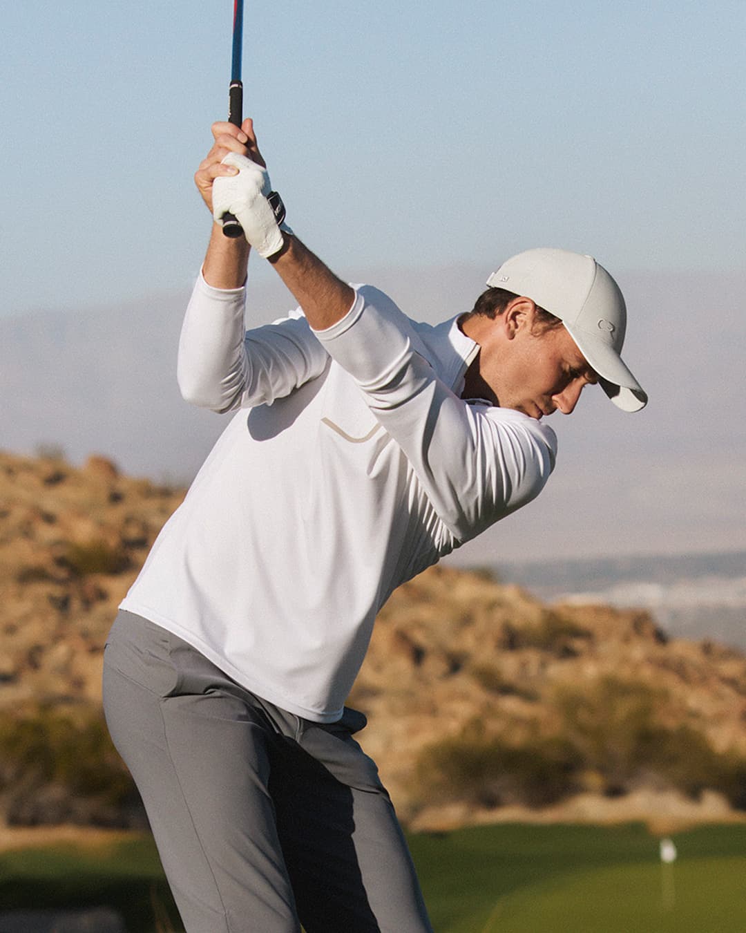 Casper Ruud wearing the off-court cap in beige while playing golf