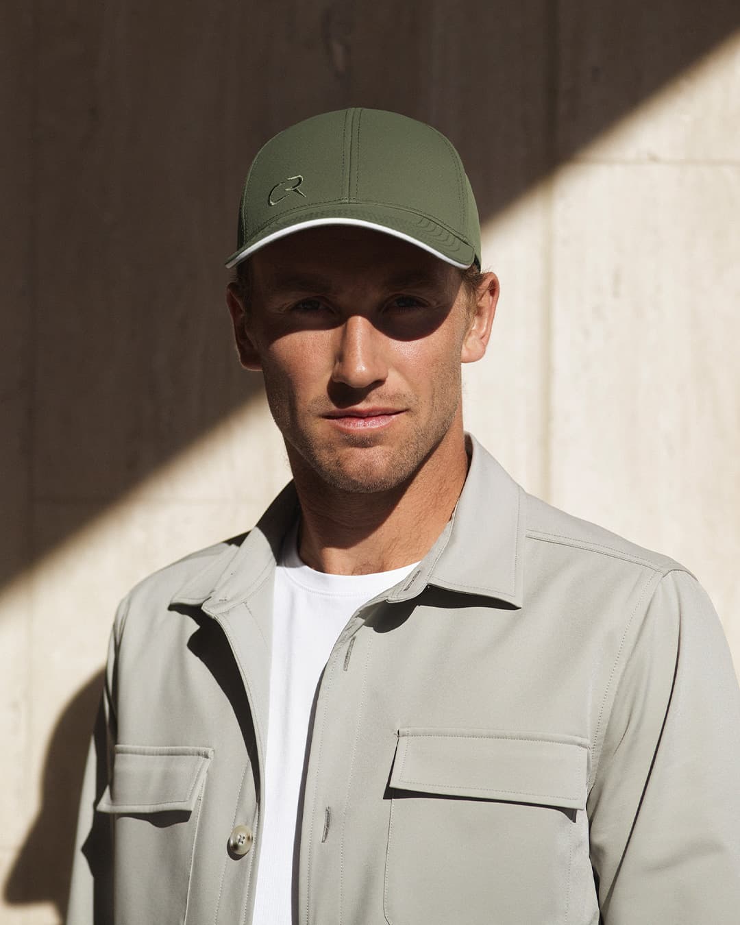 Casper Ruud wearing the off-court cap in green created in collaboration with Varsity Headwear