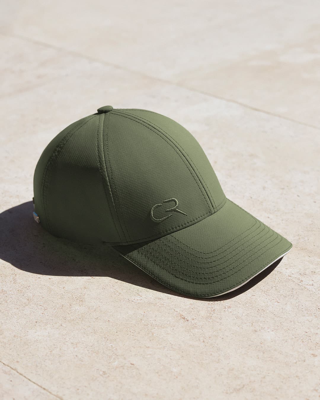 Side view of the green off-court cap designed in collaboration with Casper Ruud and Varsity Headwear