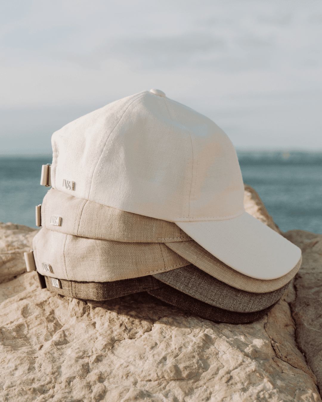 Summer linen caps in front of ocean