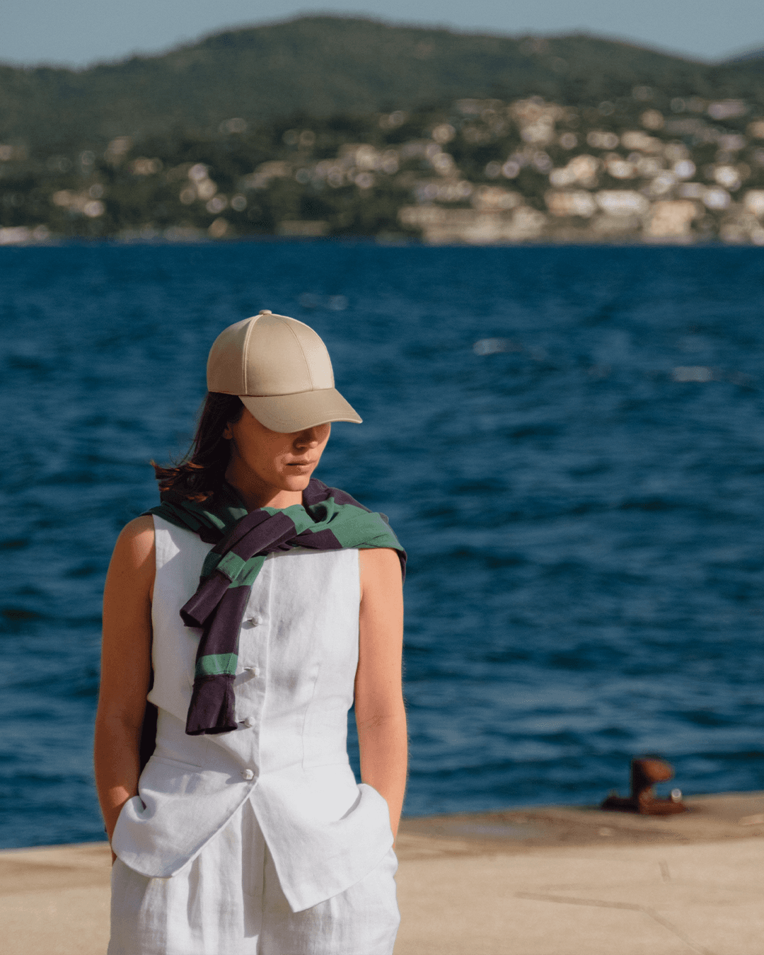 Female wearing a beige legacy structured sea island cotton cap from Varsity Headwear by the french riviera