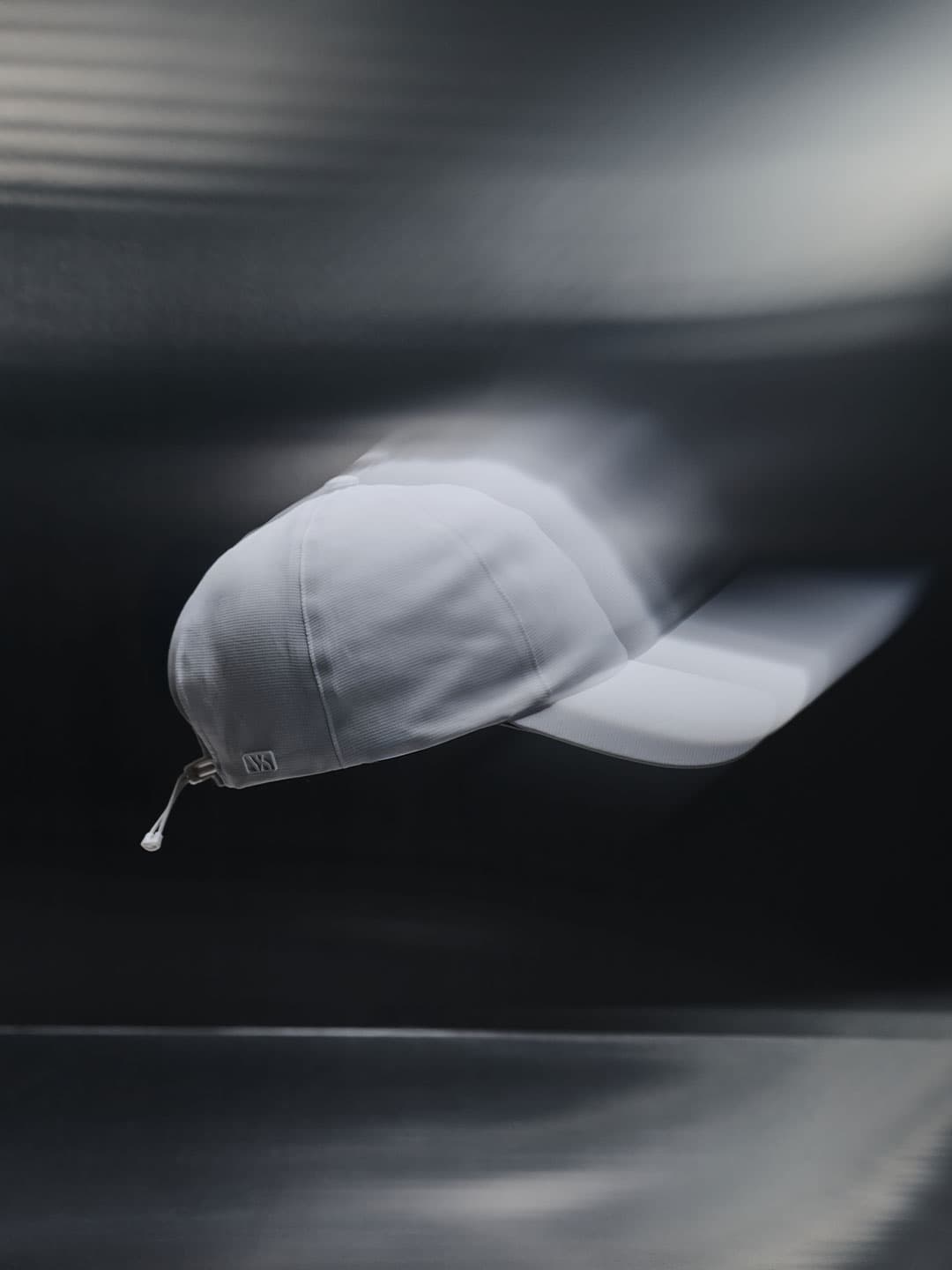 Side view of a white high intensity sport cap from Varsity Headwear with motion image effects