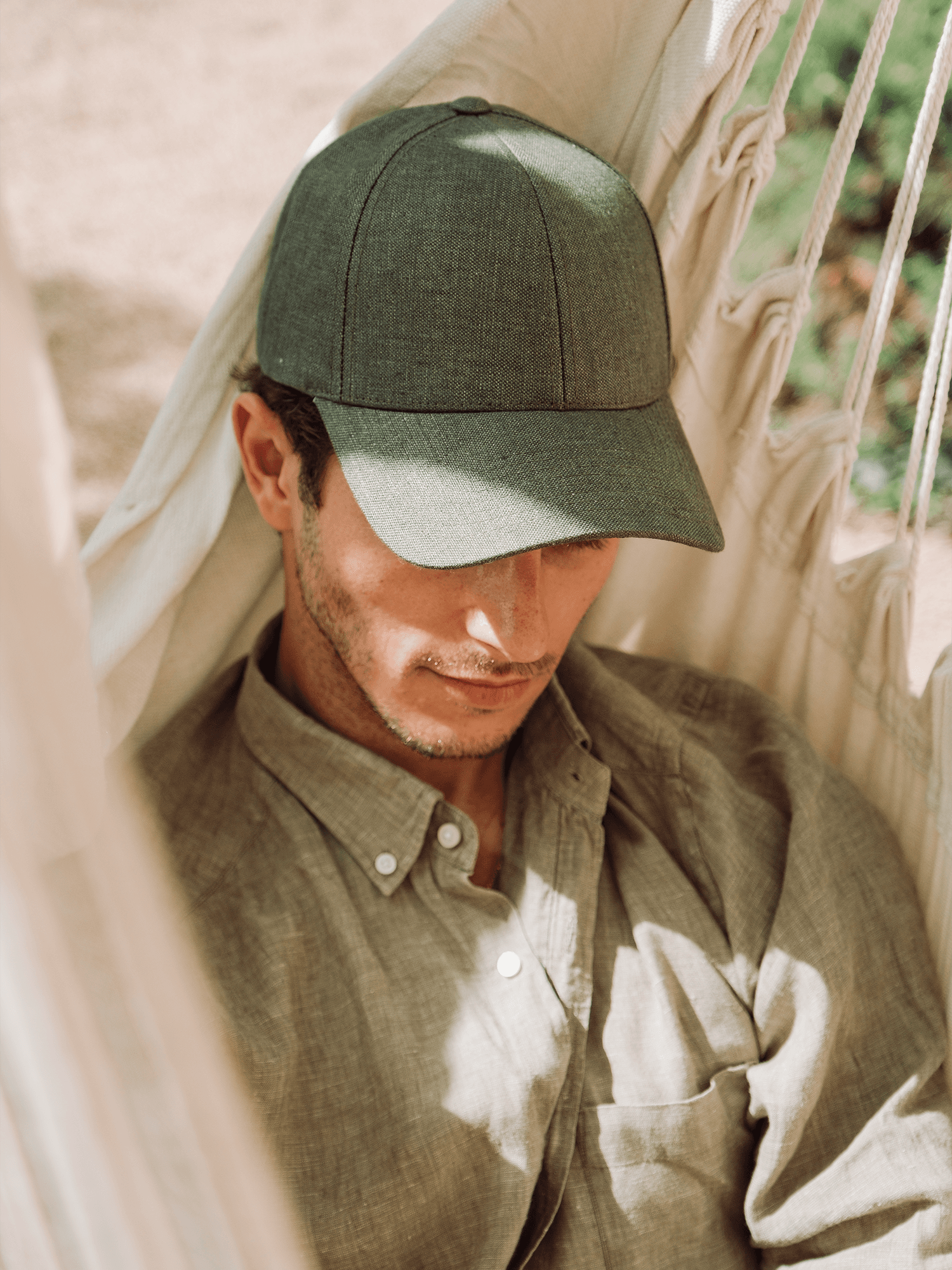 Front view of male model wearing a legacy structured french olive linen cap
