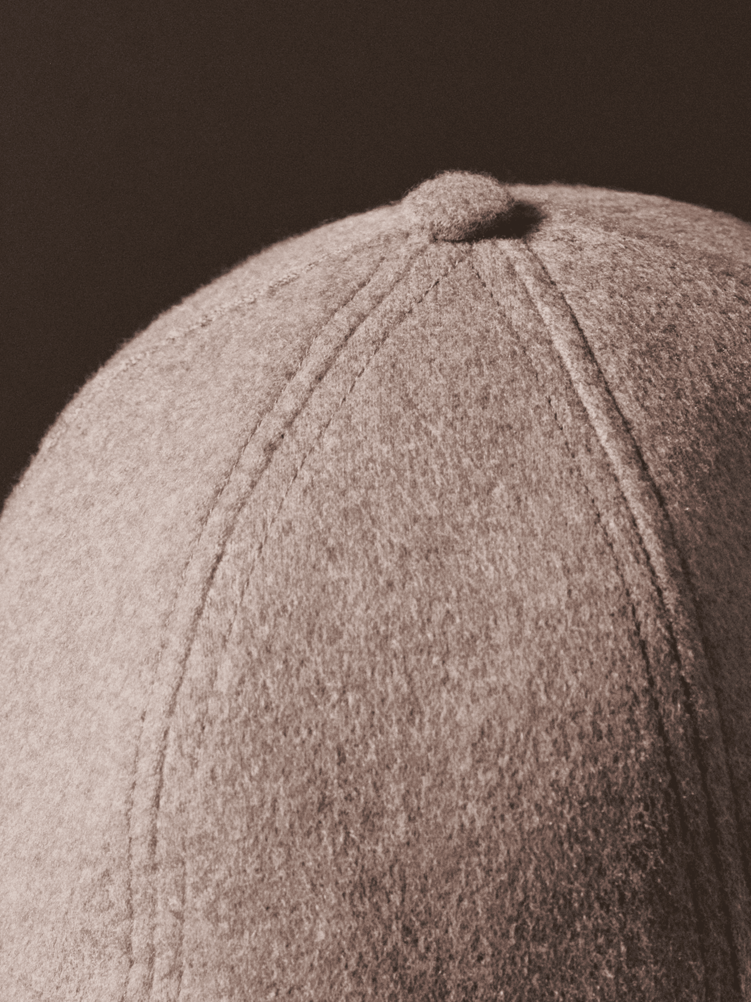 Close up image of a beige cashmere cap from varsity headwear