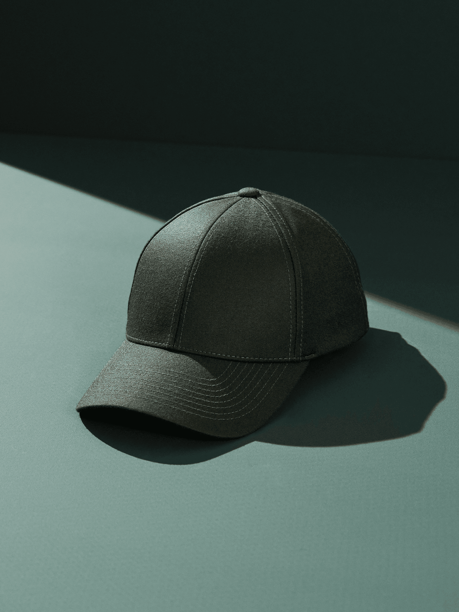 Studio image and front view of a green wool tech cap