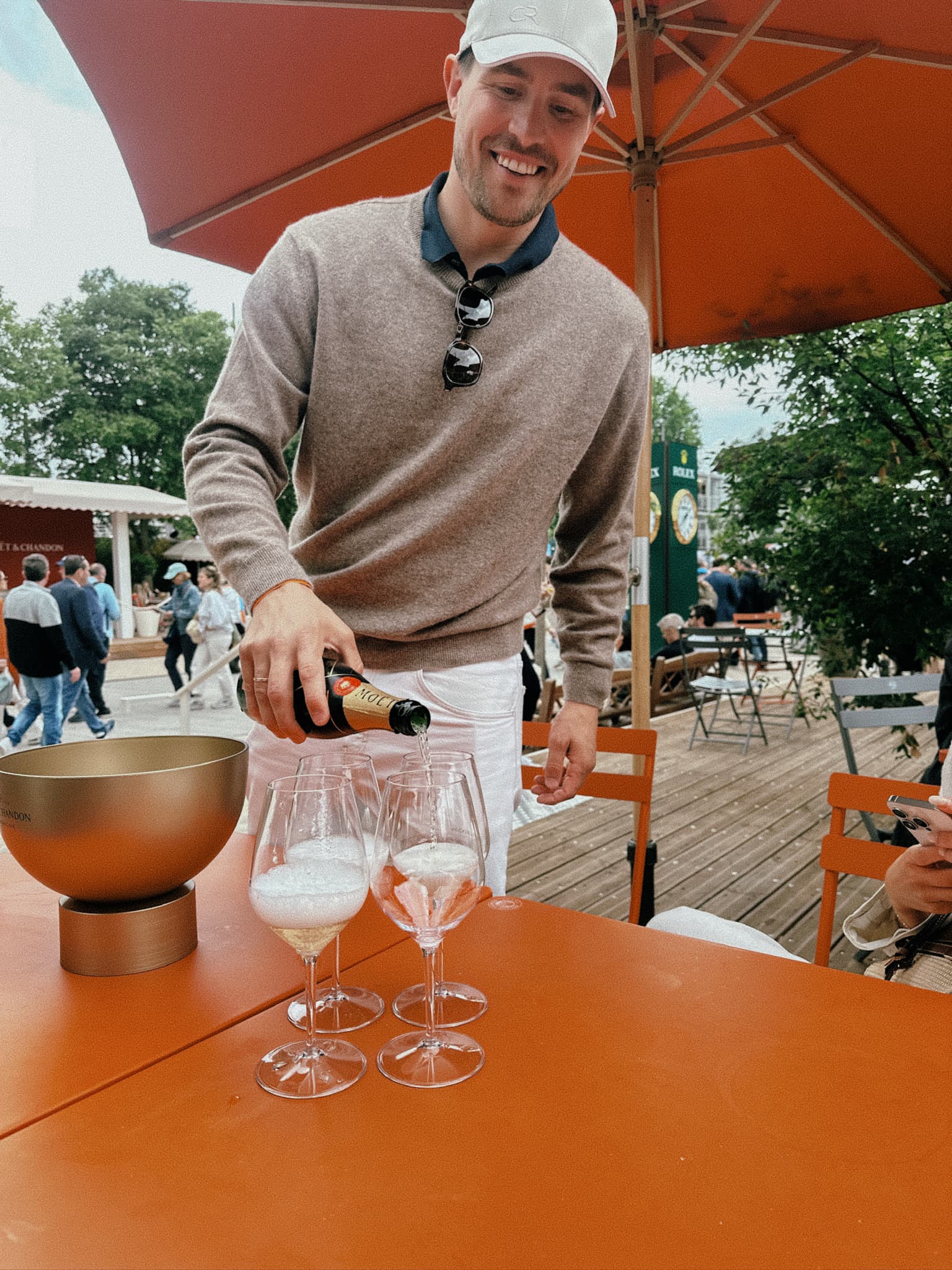 Founder of Varsity Headwear serving drinks during Paris experience