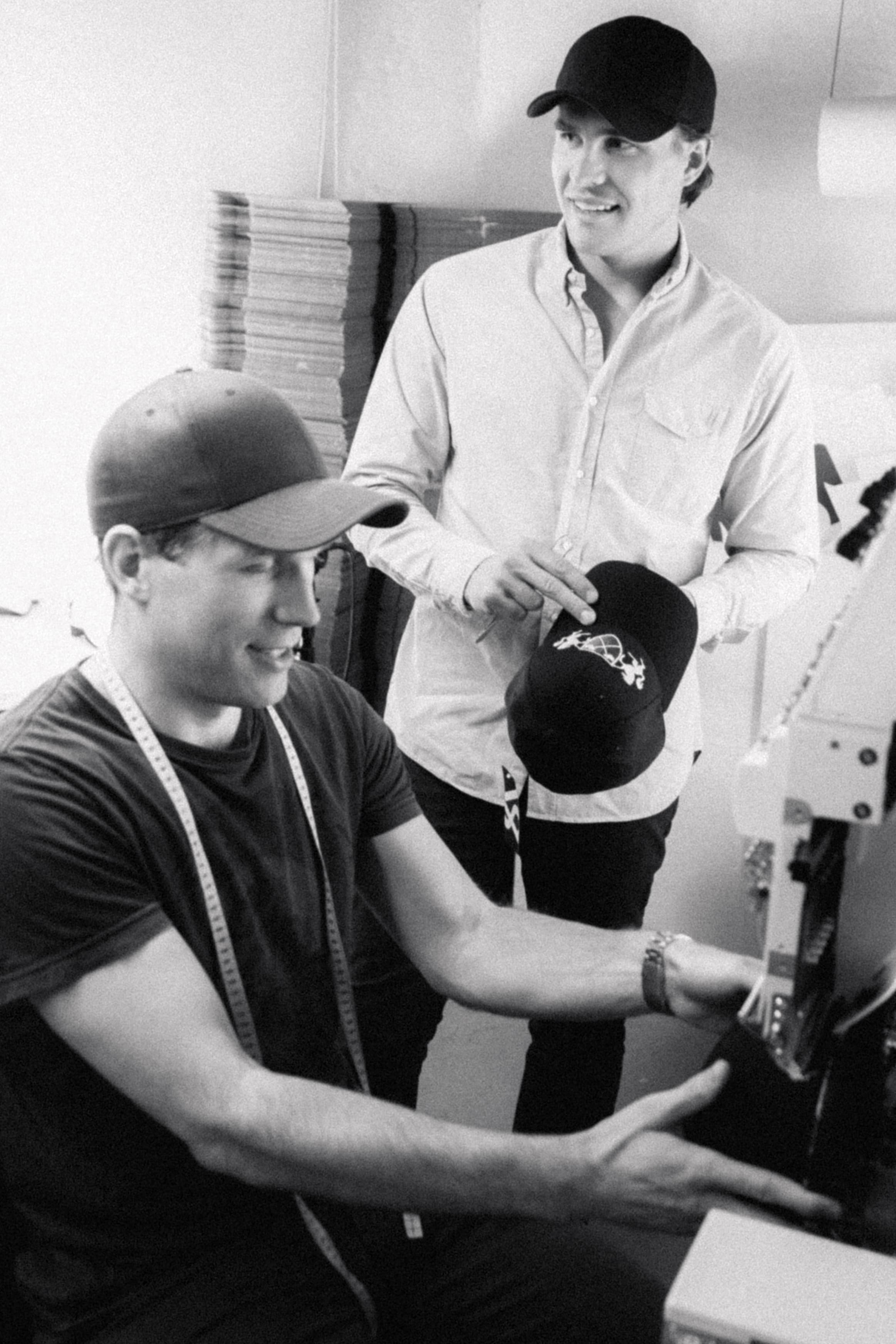 Founders of Varsity Headwear working with caps