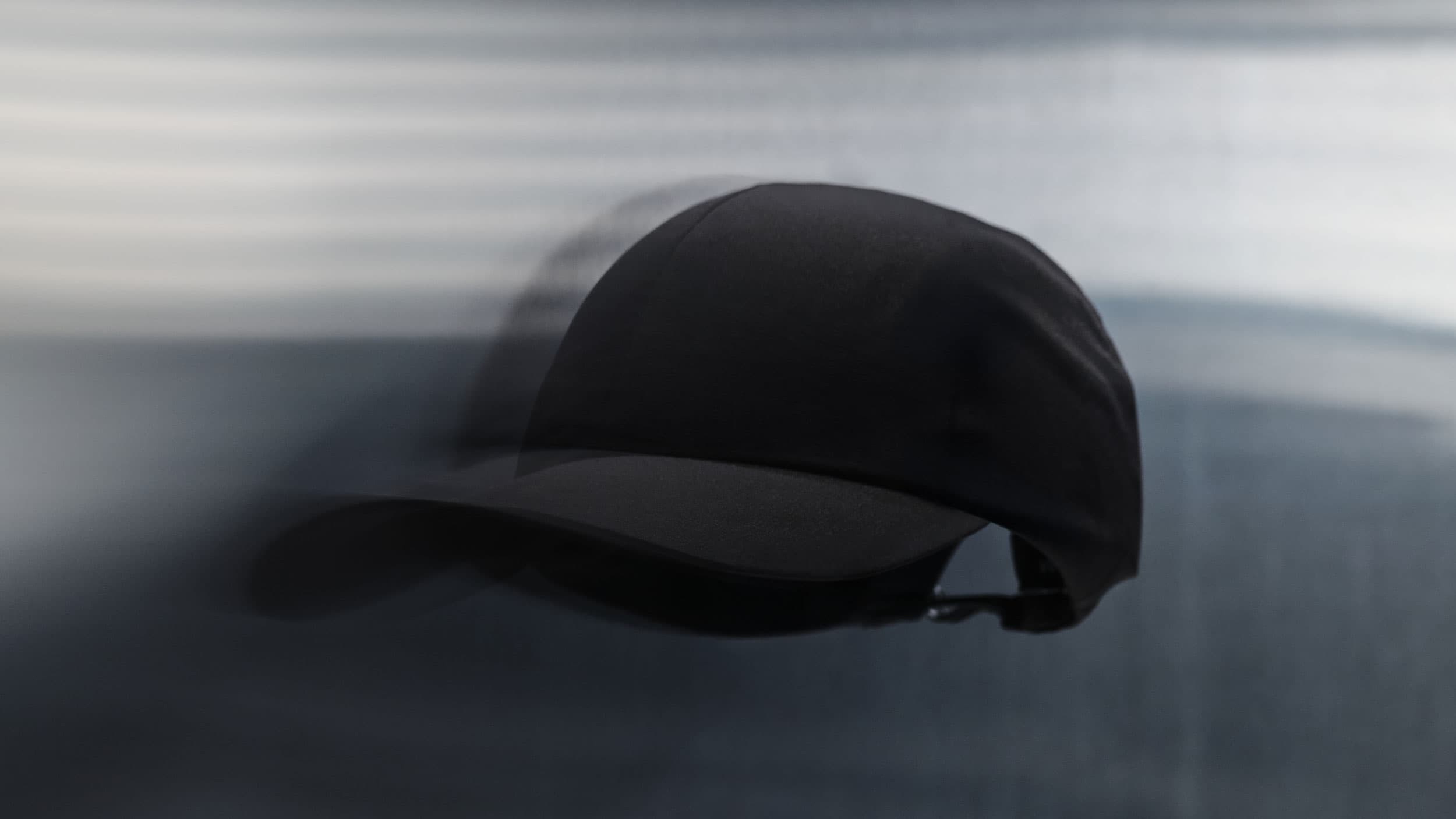 Front view of the high intensity sport cap from varsity headwear in black in motion
