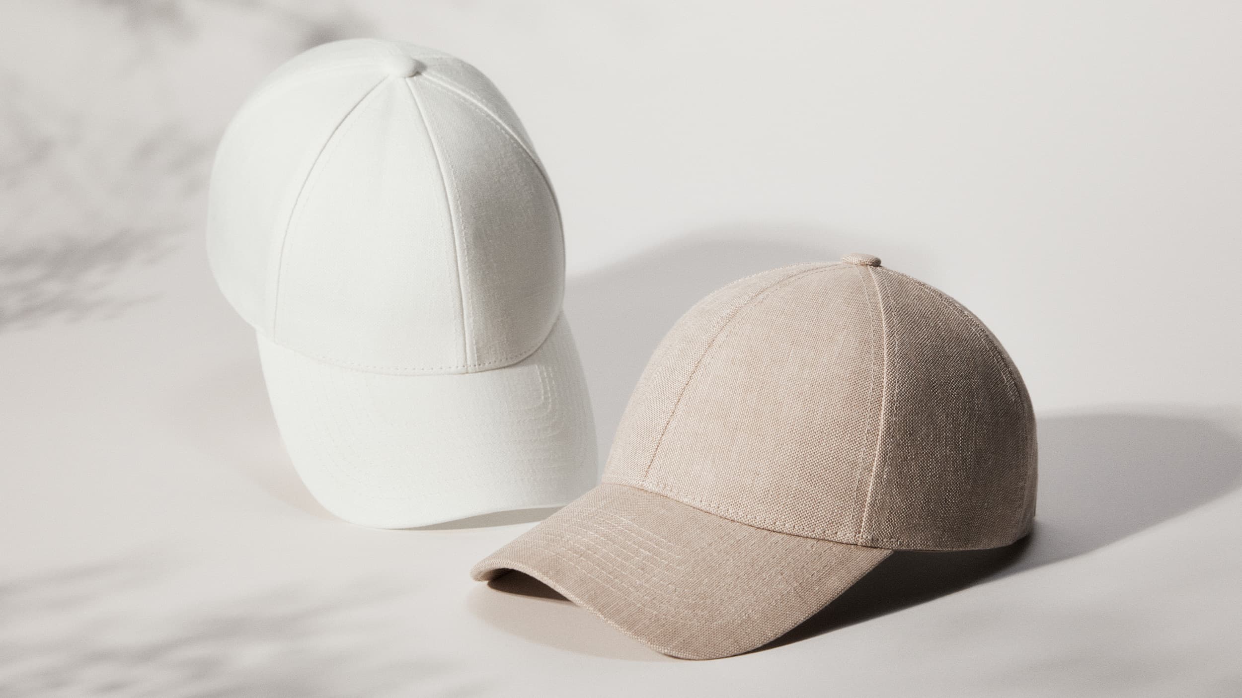 Front view of white and beige legacy structured bestseller caps from Varsity Headwear