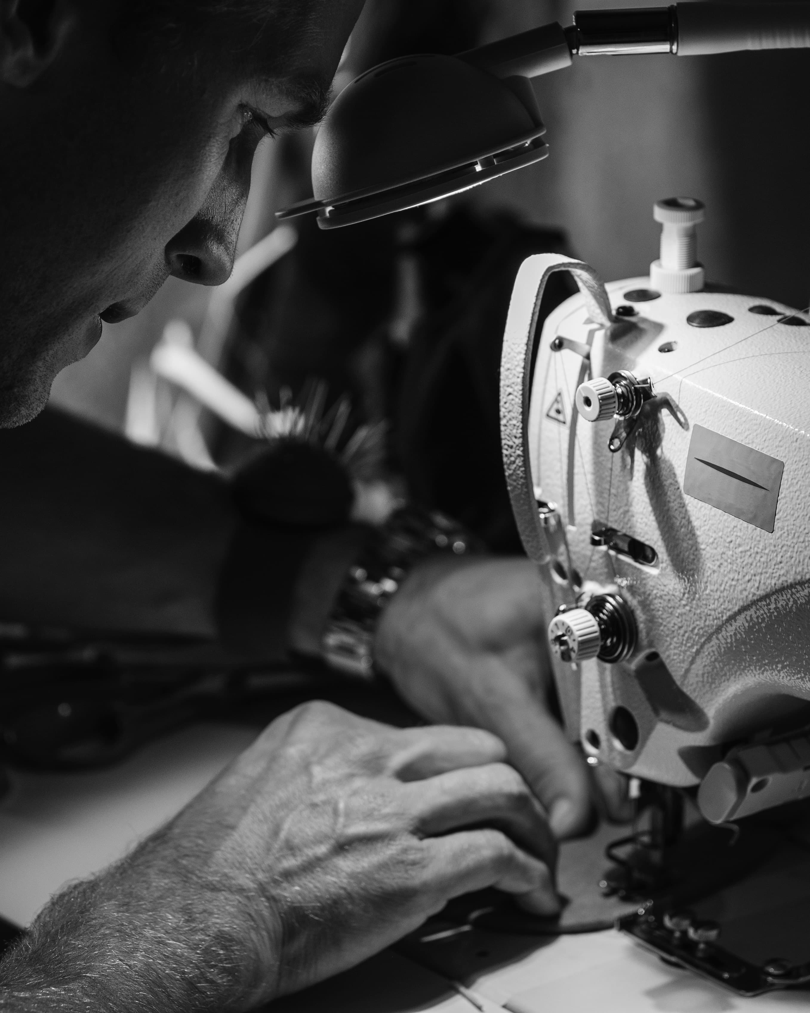Designer working with materials on sewing machine