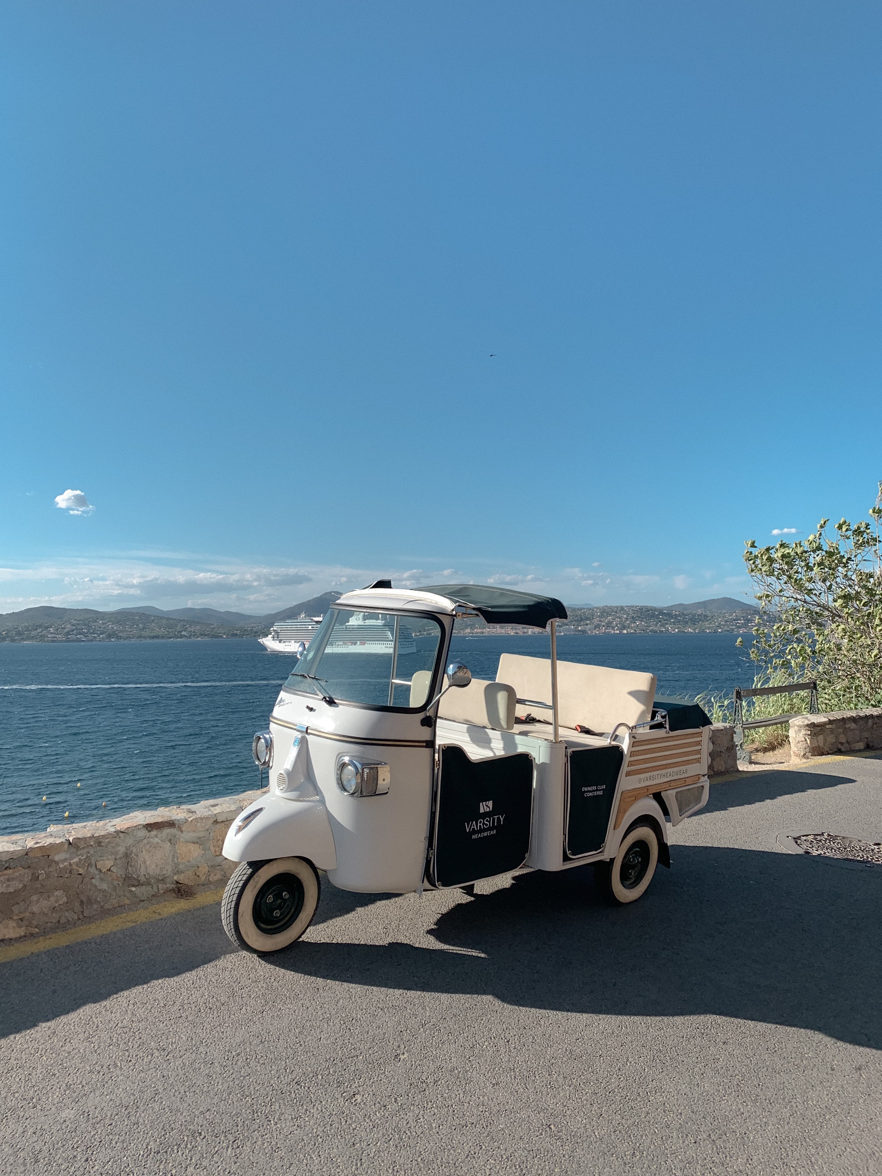 Environmetal image of branded varsity headwear retro car in the streets of Saint Tropez