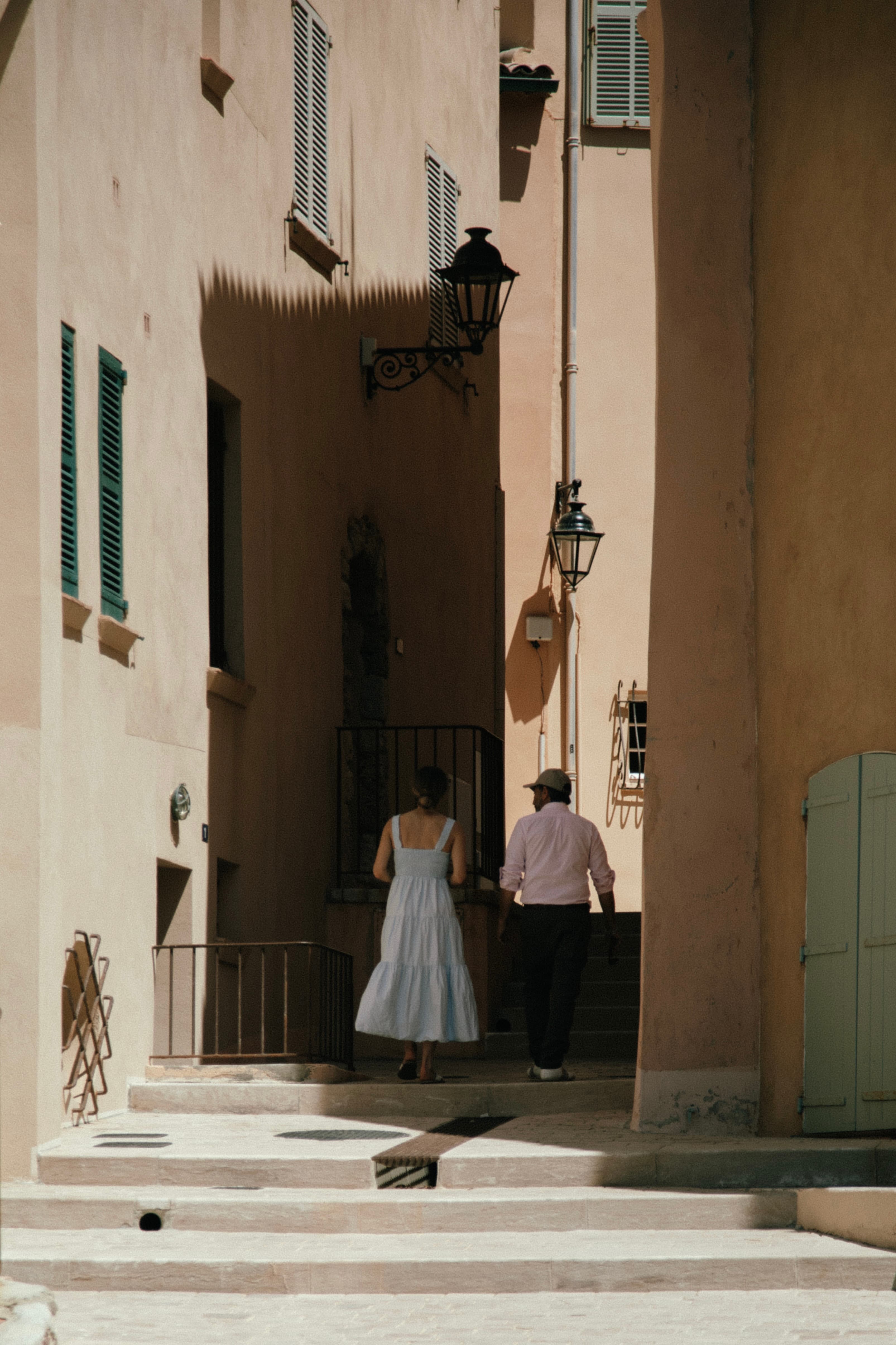 Couple walking up the stairs in old town Saint Tropez