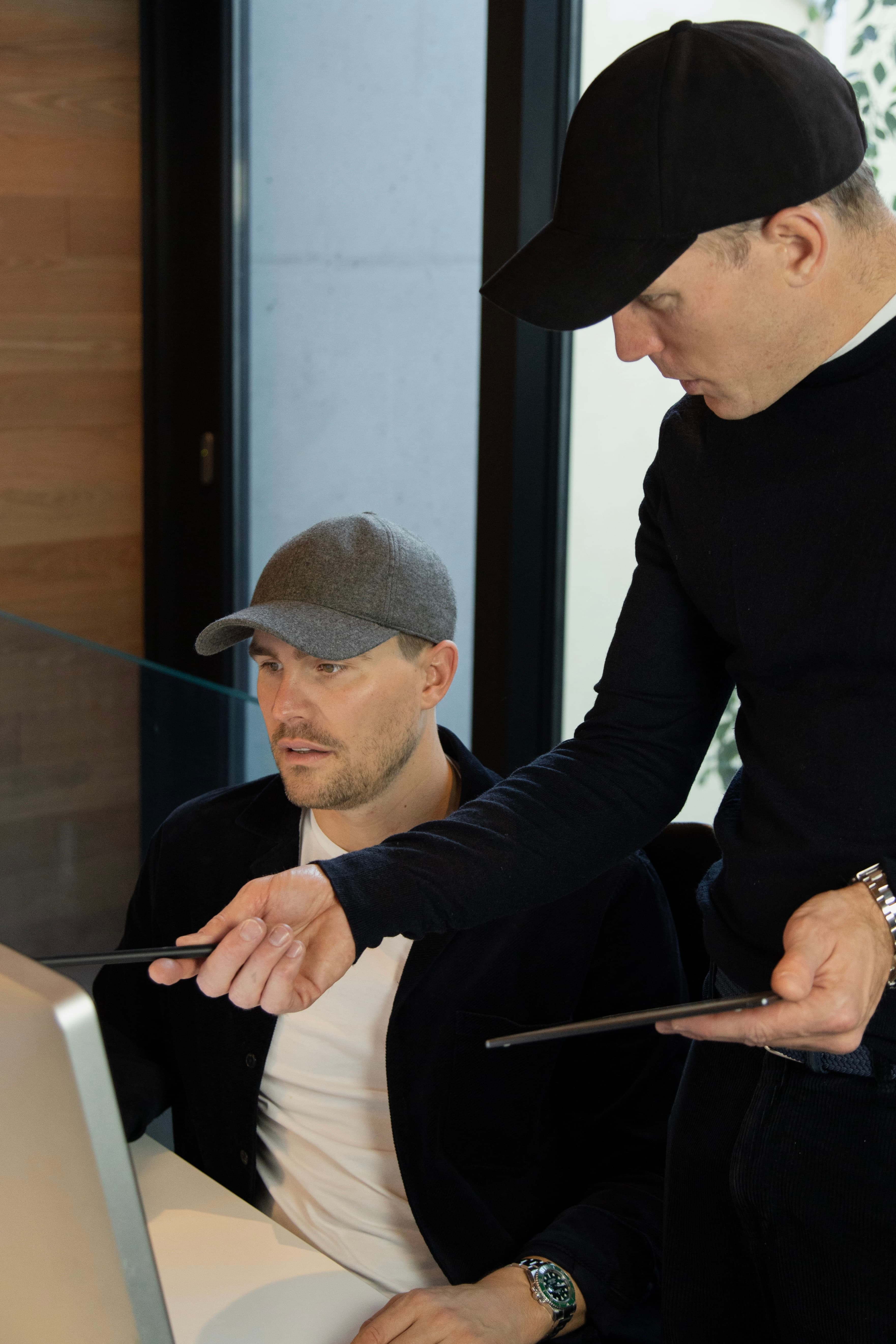 Founders of Varsity Headwear working with beanies in their office in Oslo Norway