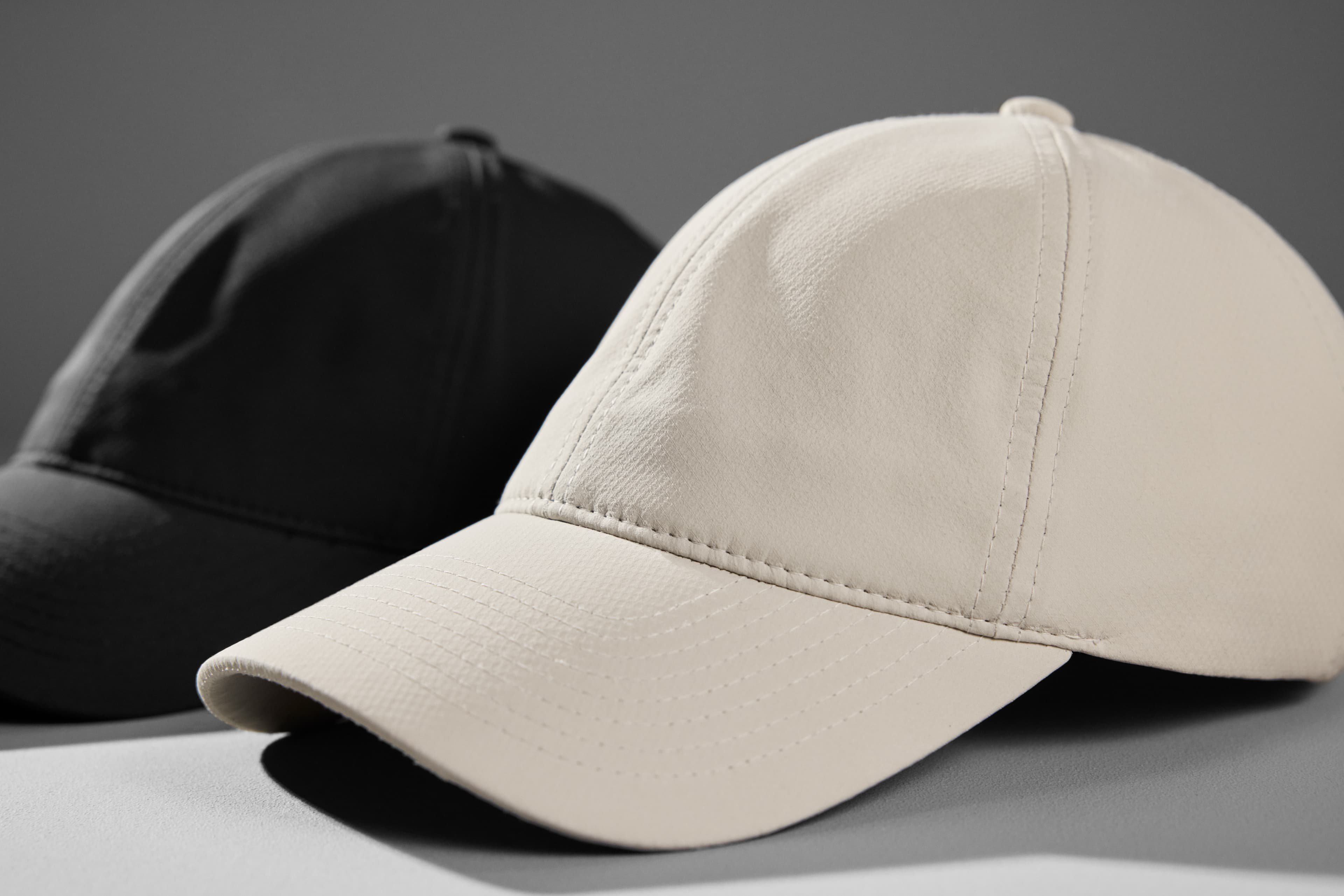 Side view of black and white legacy soft active tech caps