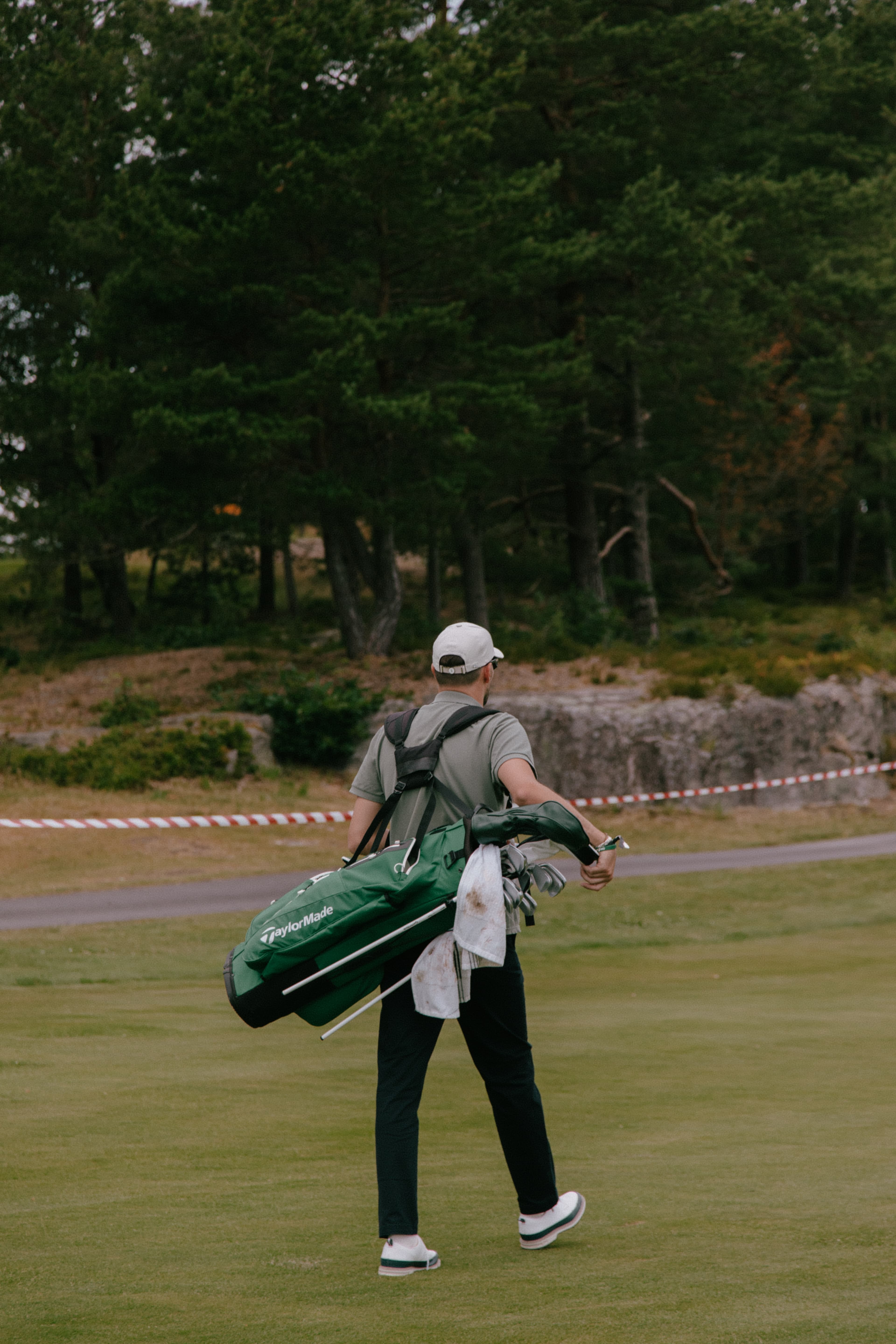 Back view of golf player wearing Varsity Headwear cap