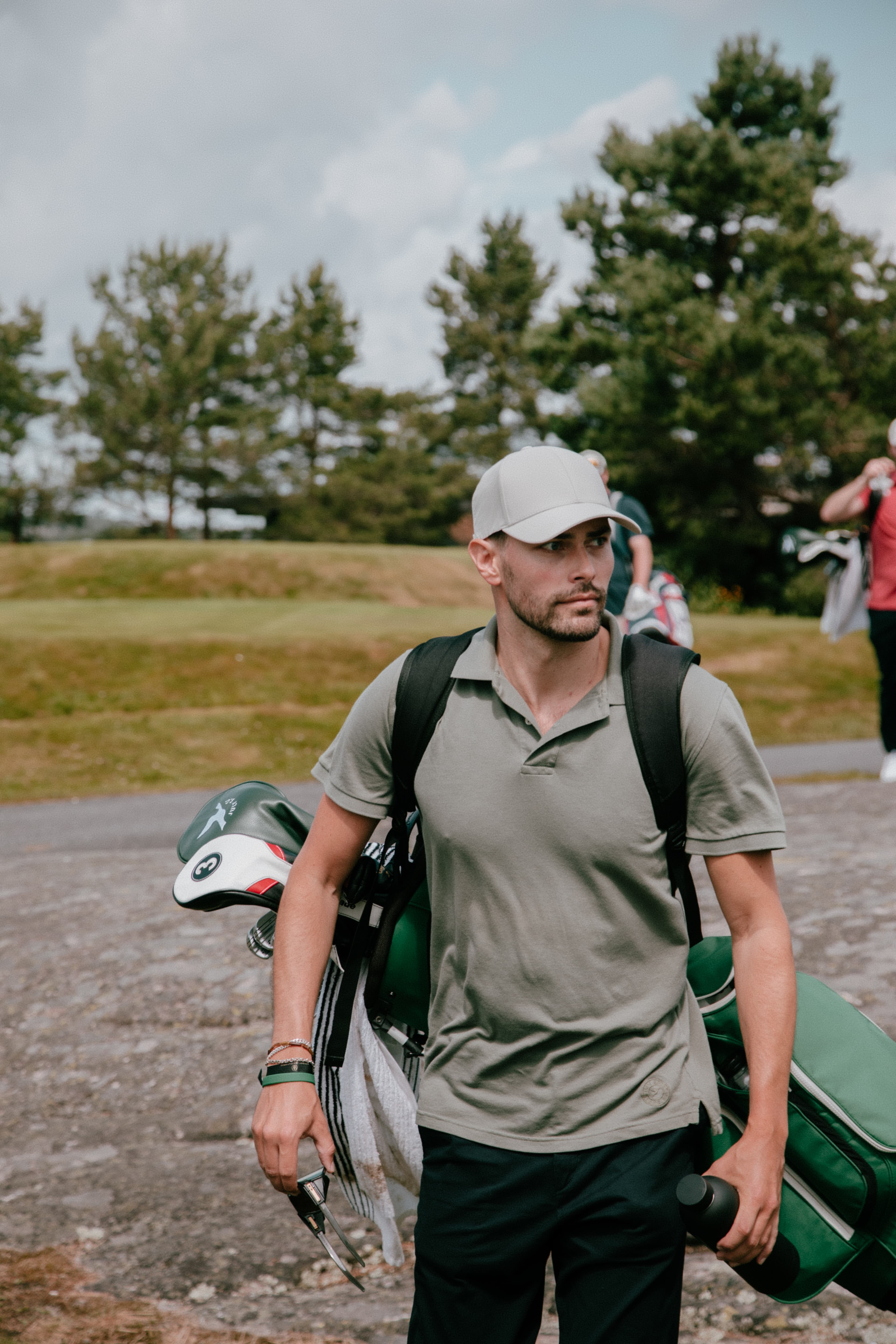 Front view of golf player wearing varsity headwear cap on golf course