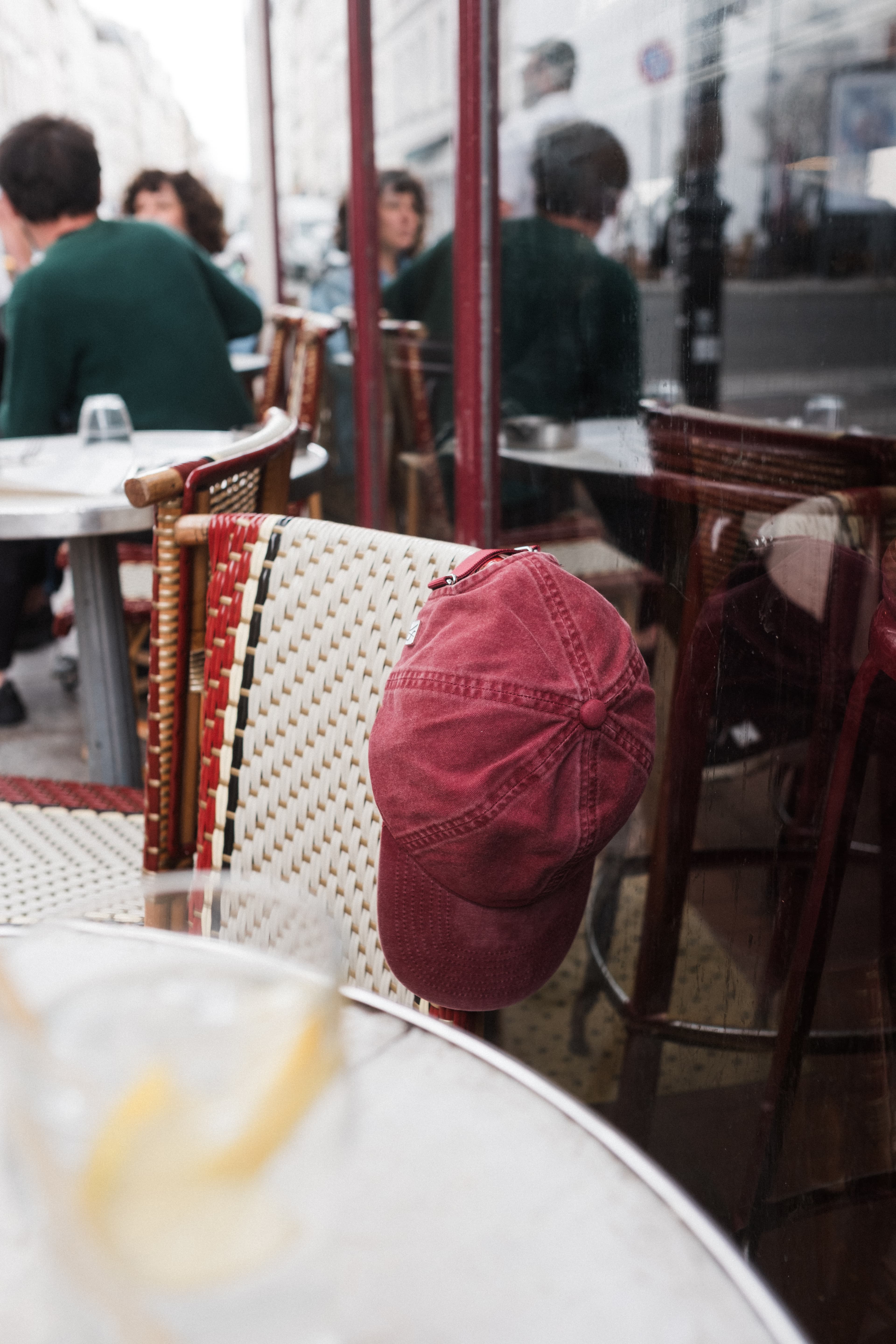 Burgundy washed cotton cap at cafe in Paris