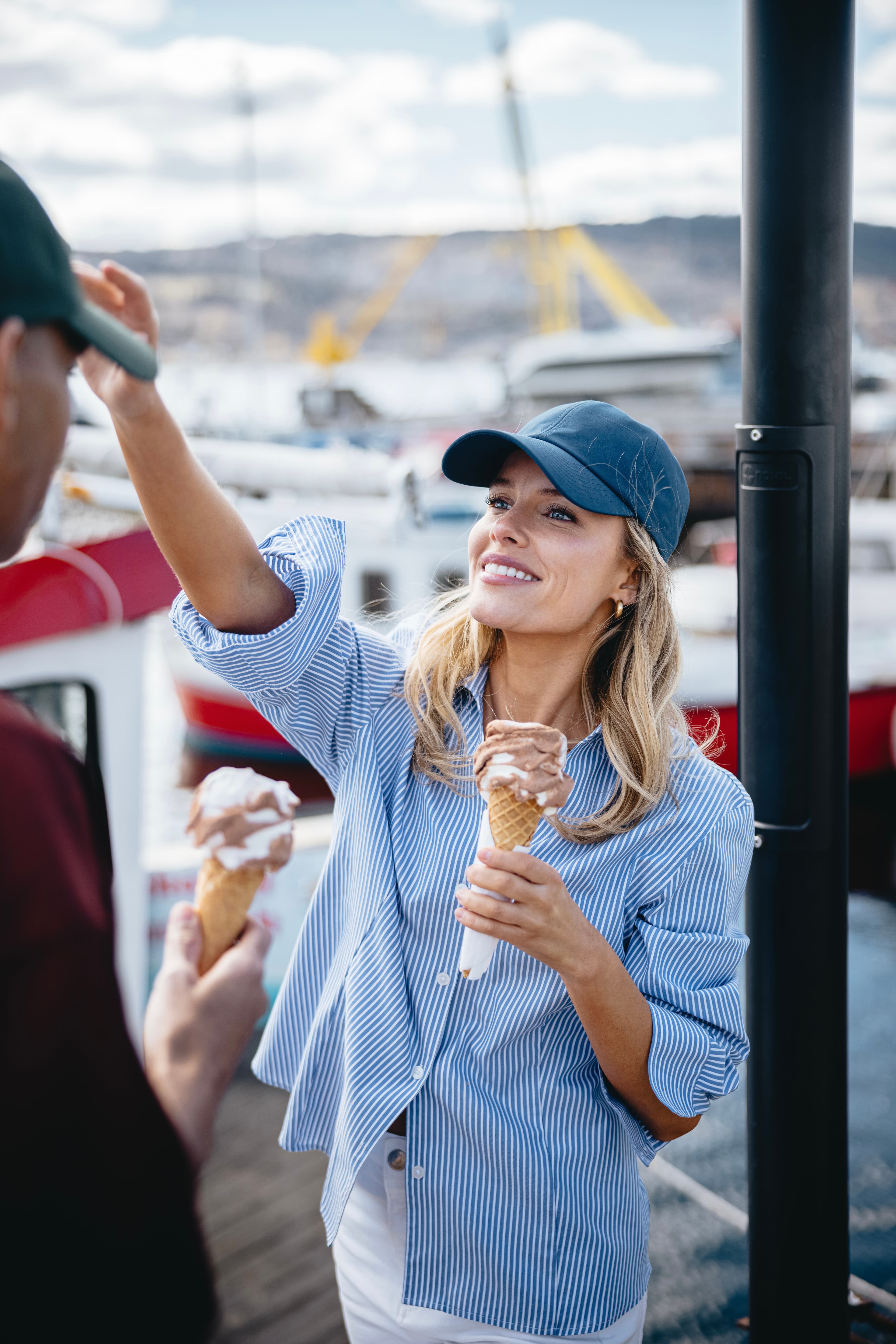Female wearing seaqual cap while eating ice cream during summer