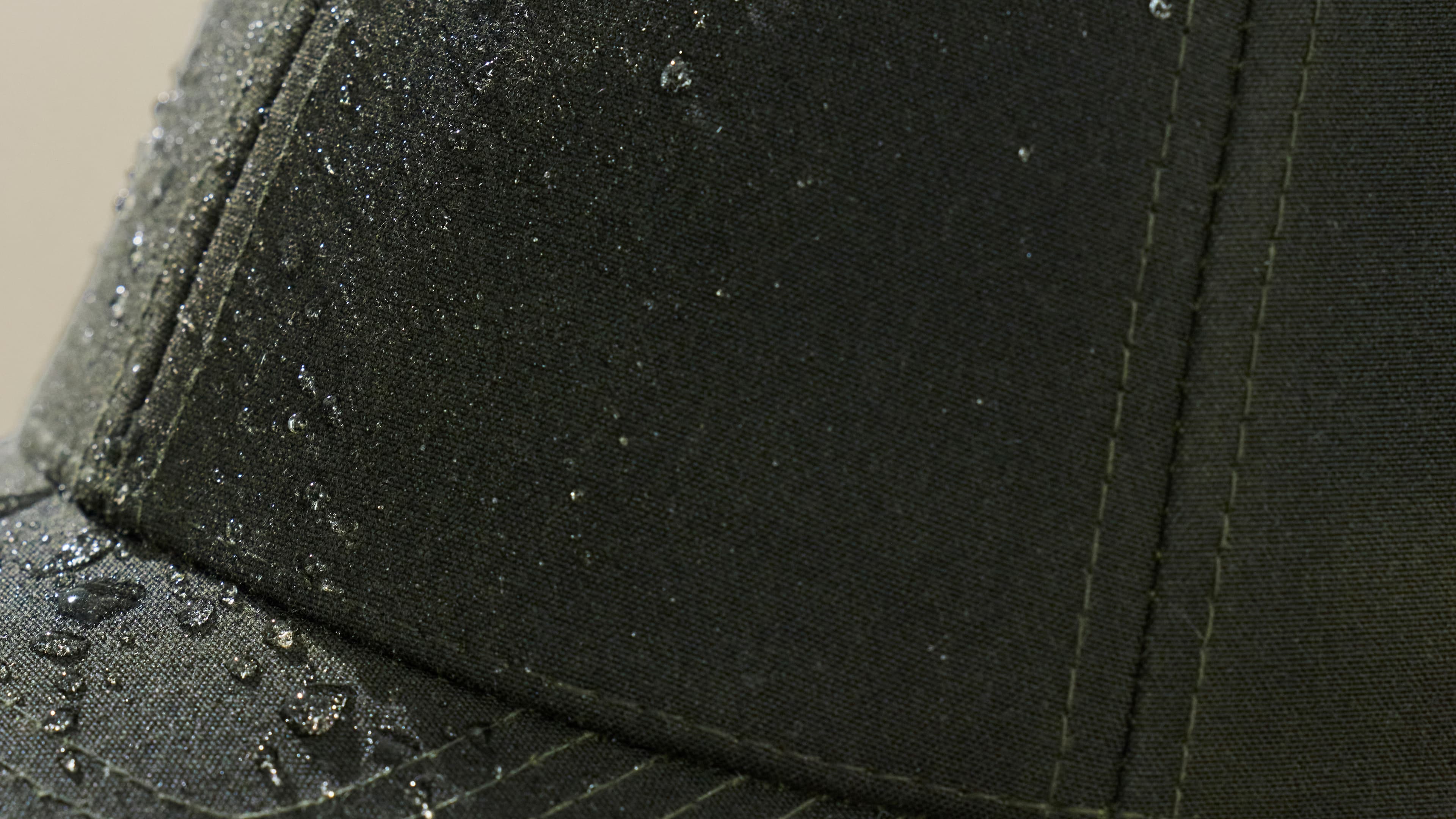 Close view showing the water resistant features of the materials in an oilskin cap from varsity headwear
