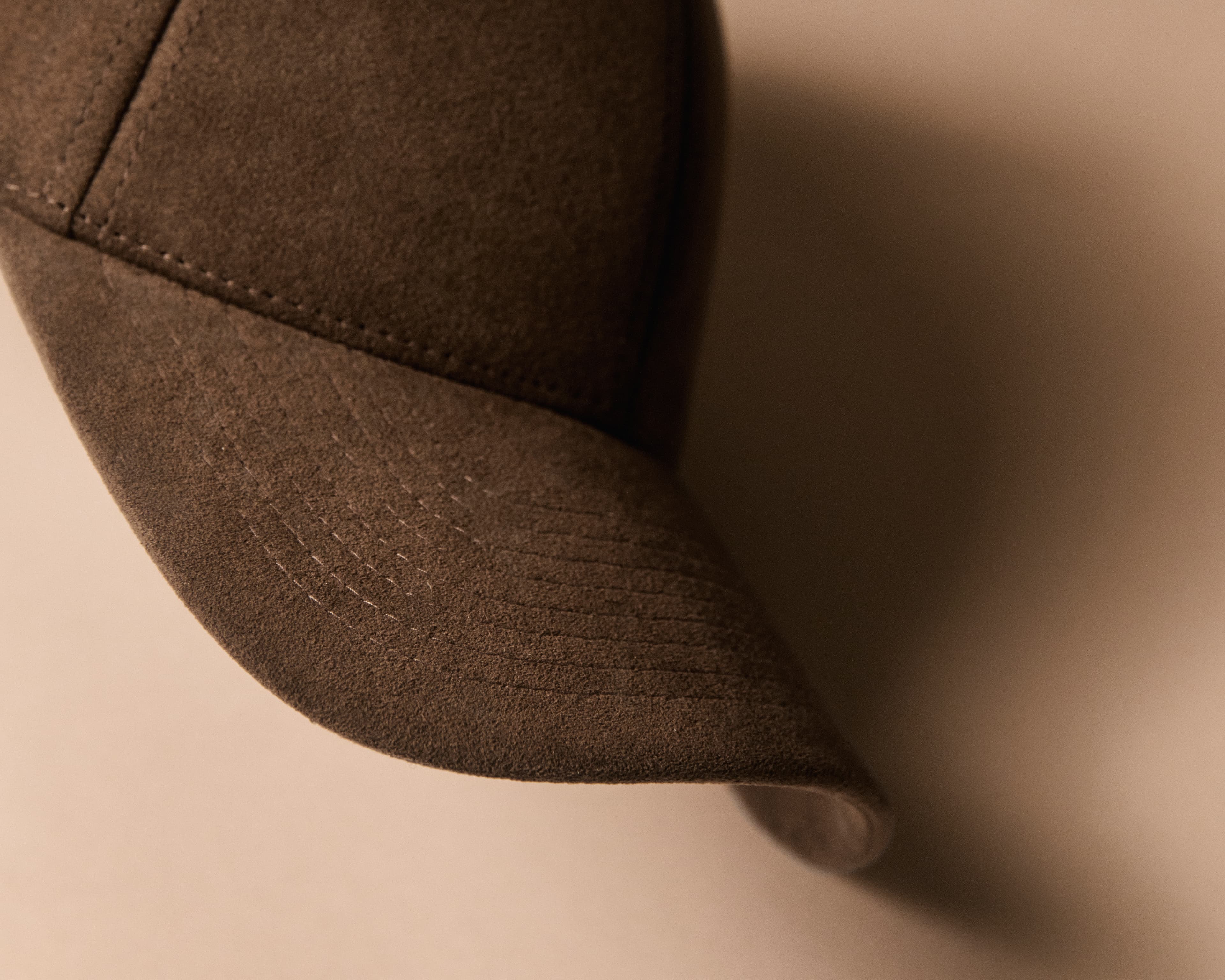 Close view of a brown alcantara cap from varsity headwear
