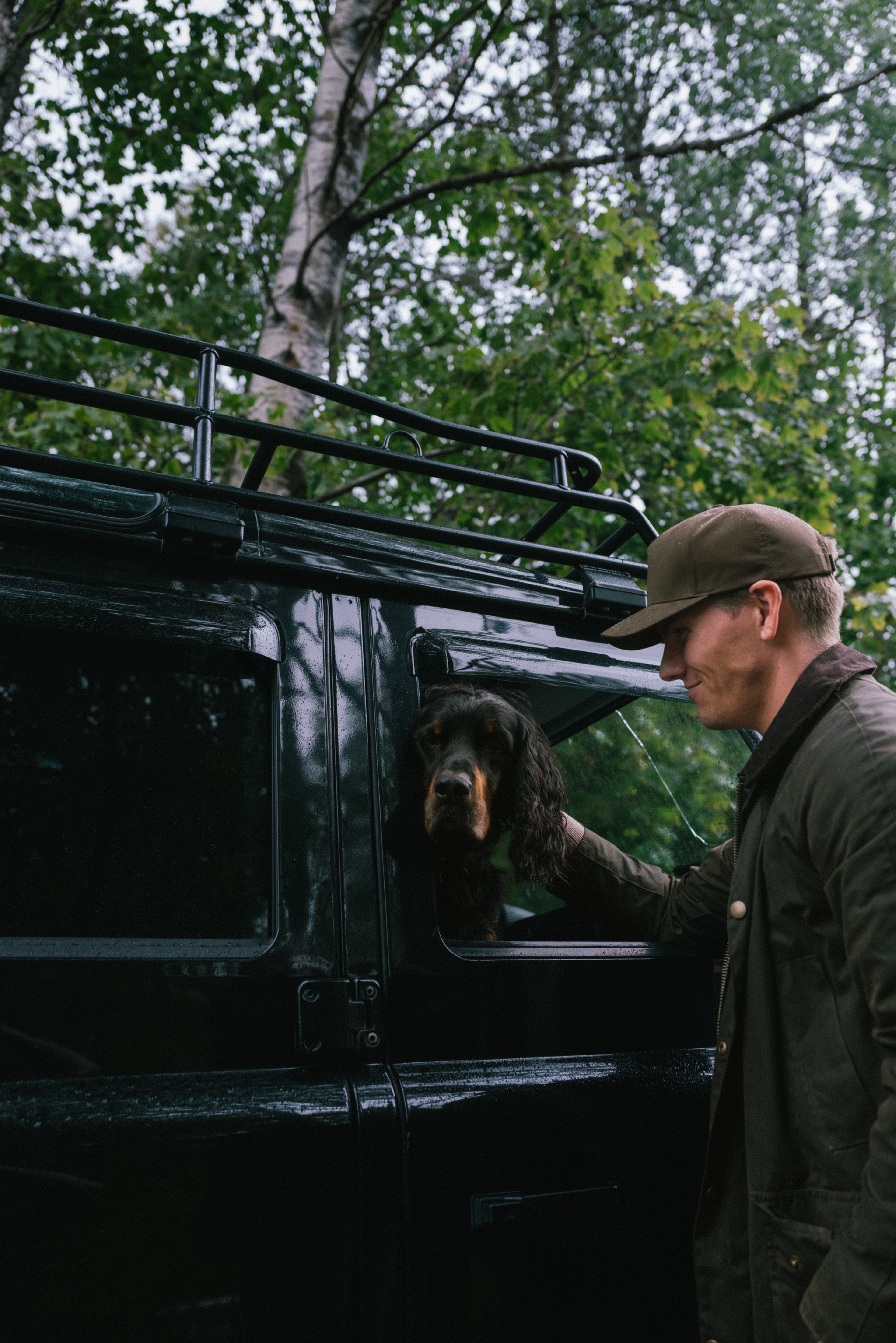 Male wearing ventile cotton Cruz cap in the woods with dog