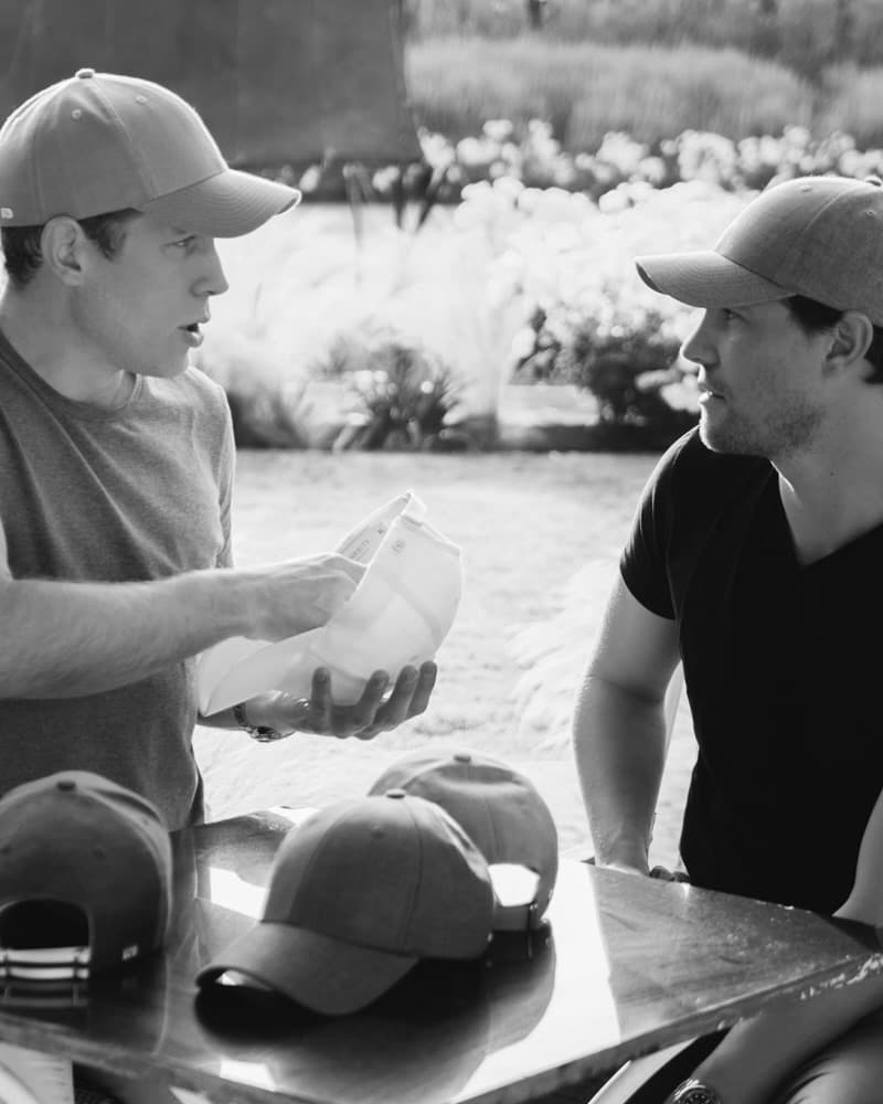 Founders of Varsity Headwear looking at cap shapes