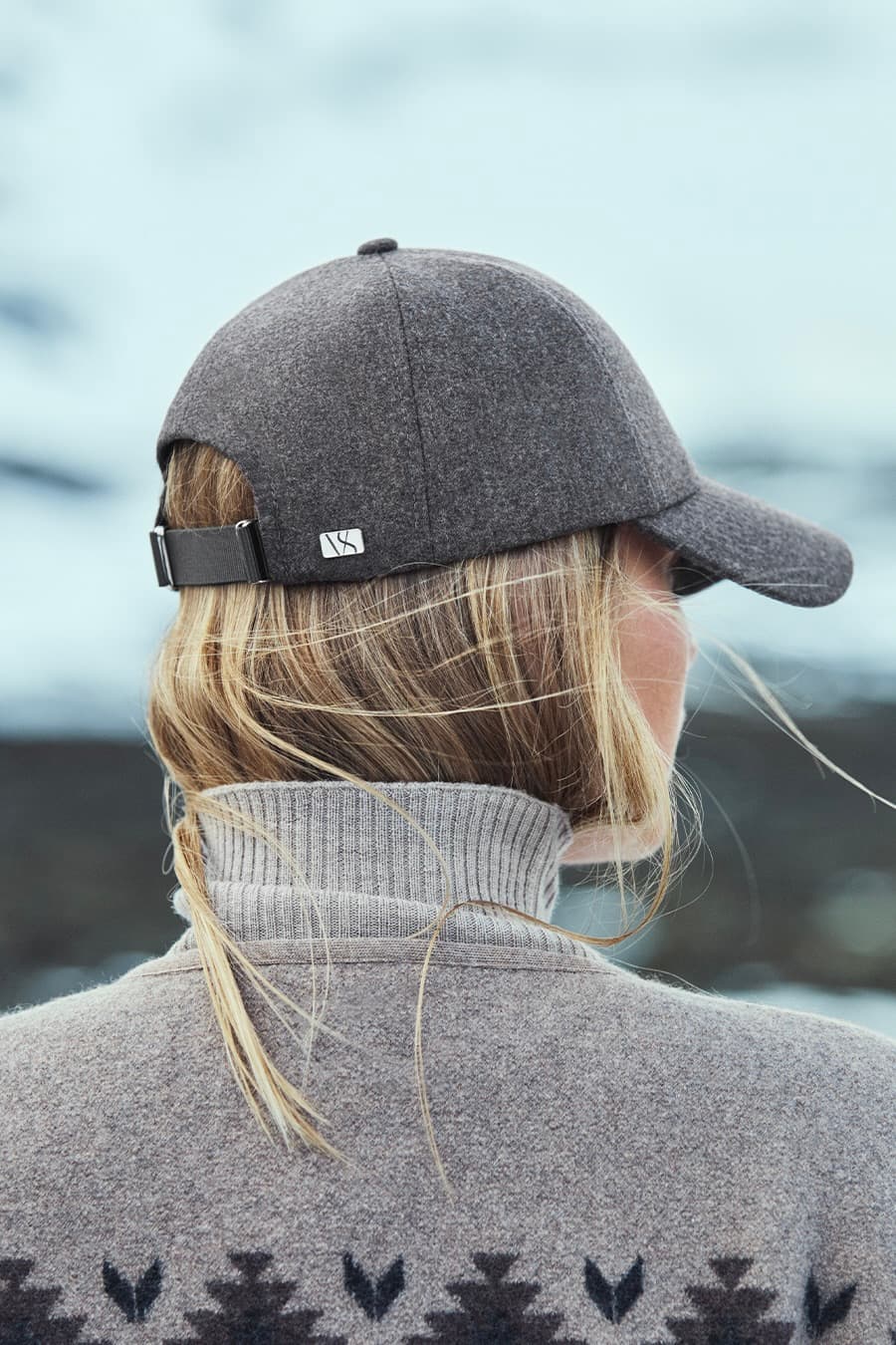 Back view of a brown virgin wool cap from varsity headwear in Nordic landscape
