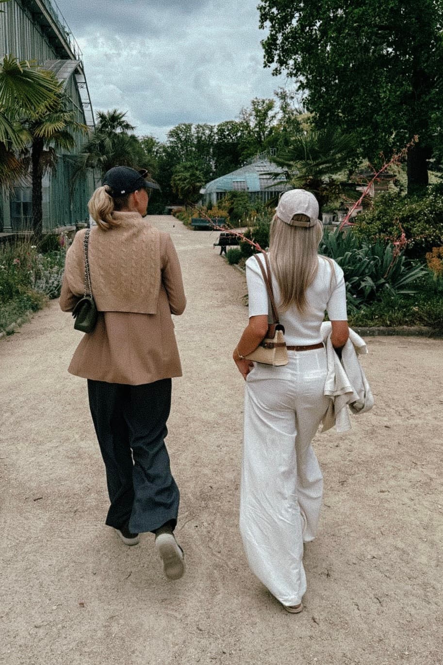 Two girls wearing varsity headwear caps in the streets of Paris