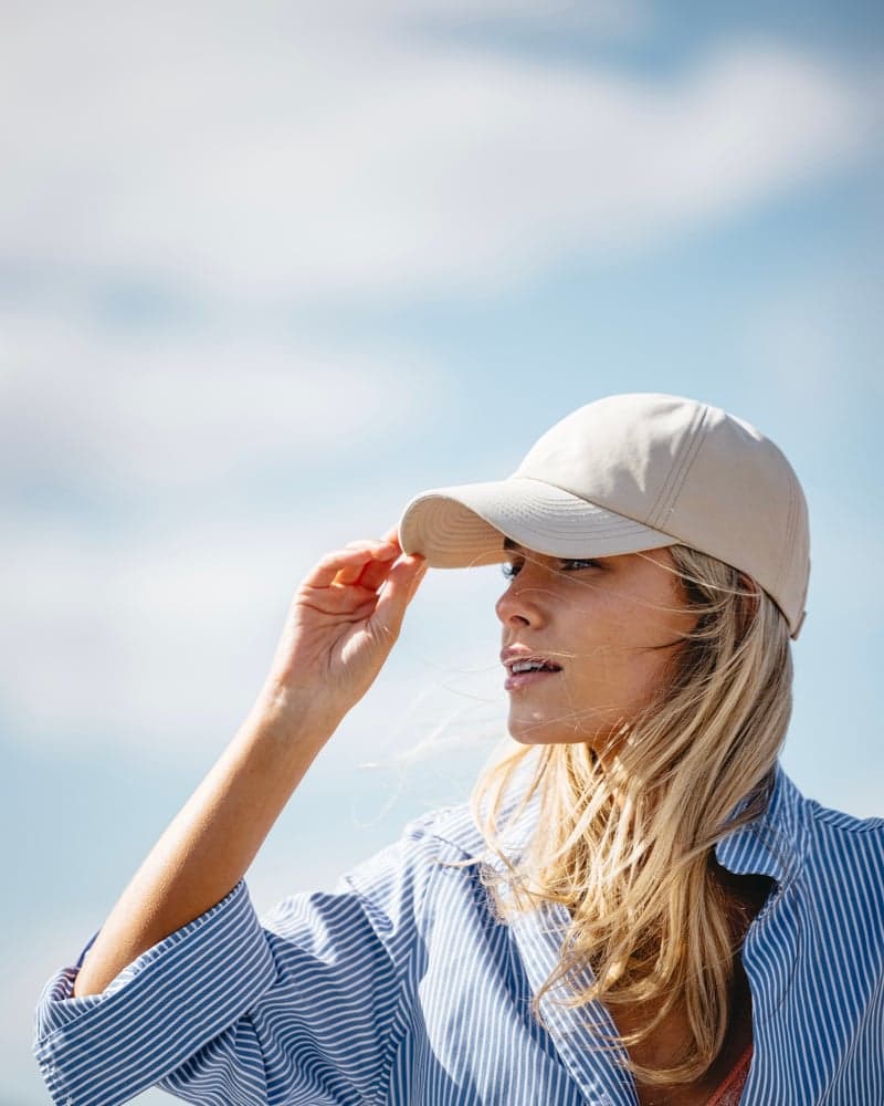 Side view of female model wearing a legacy soft seaqual cap in summer environment