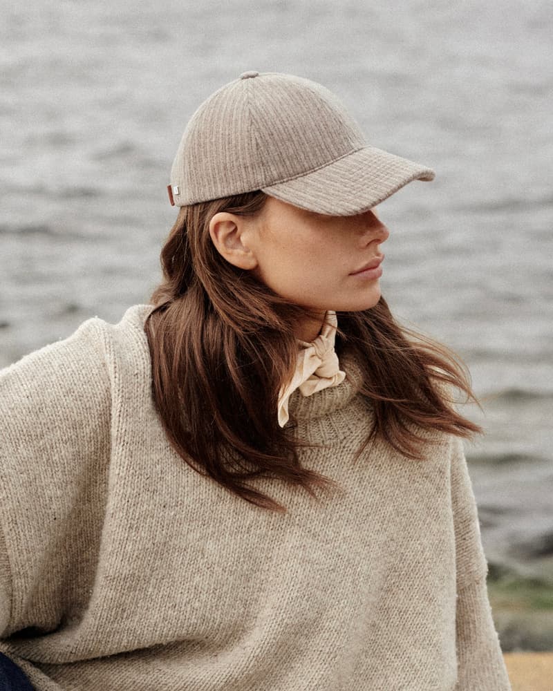 Side view of female model wearing corduroy wool cap from varsity headwear
